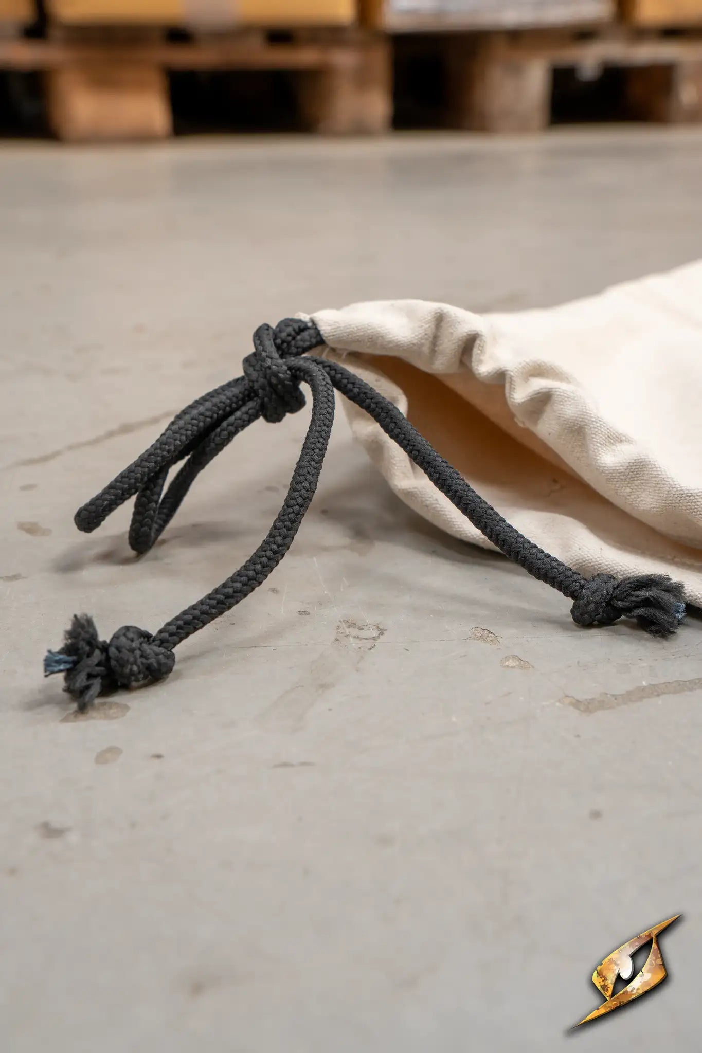 Bag for poles with secure drawstring closure on a textured surface