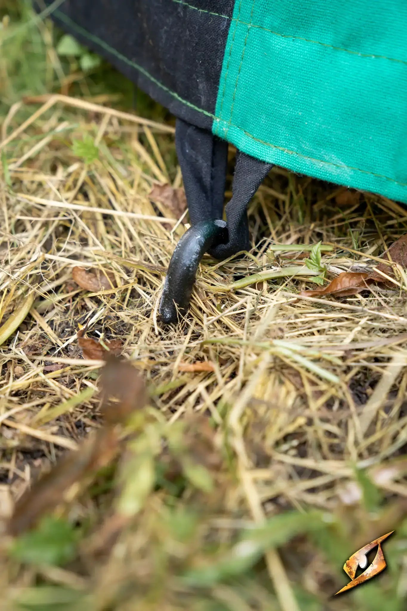 Marquee Tent - Sides - 5x8m showing a peg securing the sidewall to the ground in grassy terrain.
