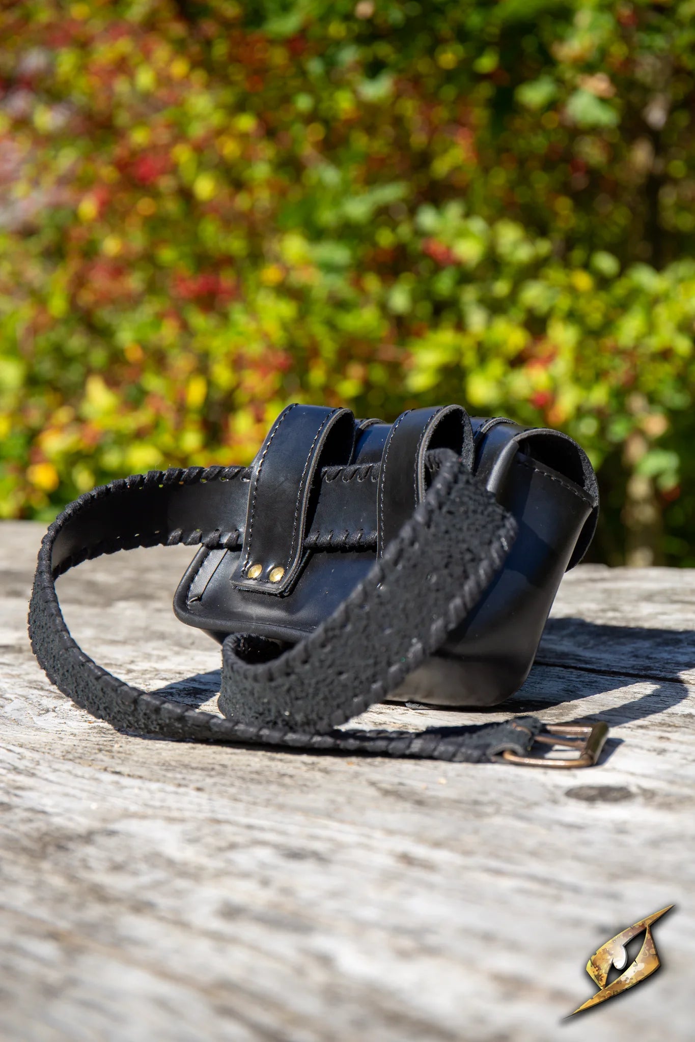 Warrior Bag - Faux Leather - Large side view on wooden surface with greenery background.