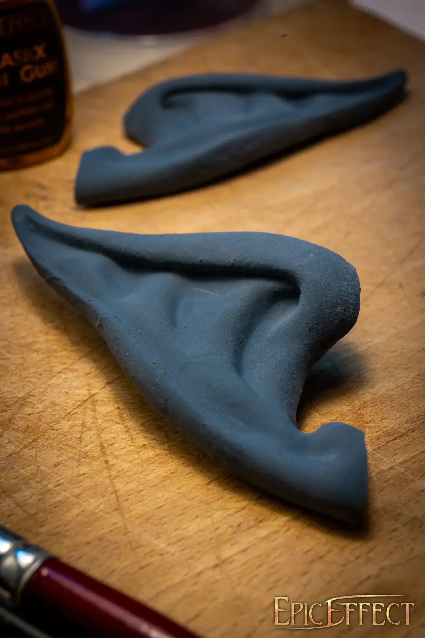 Elven Ears Long crafted from gray material on a wooden surface, perfect for cosplay or costume use.