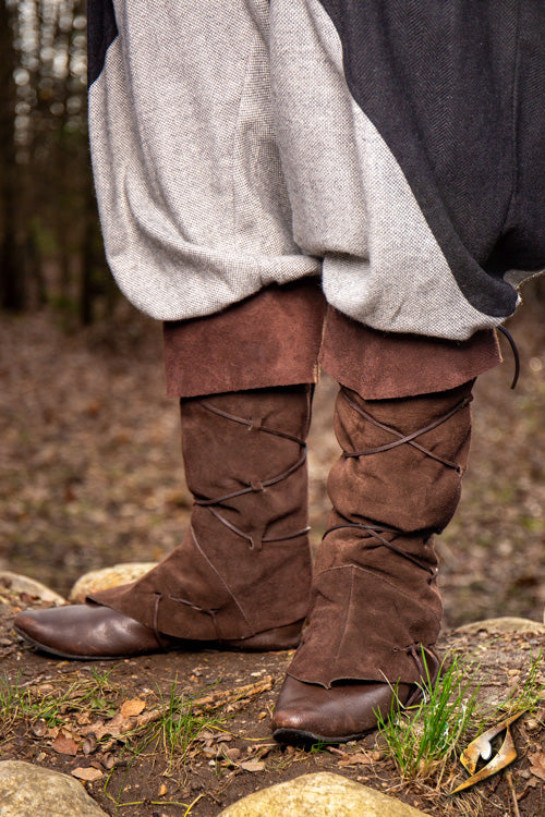 Theoderic gaiters worn with loose trousers in a natural outdoor setting, showcasing their rugged style.