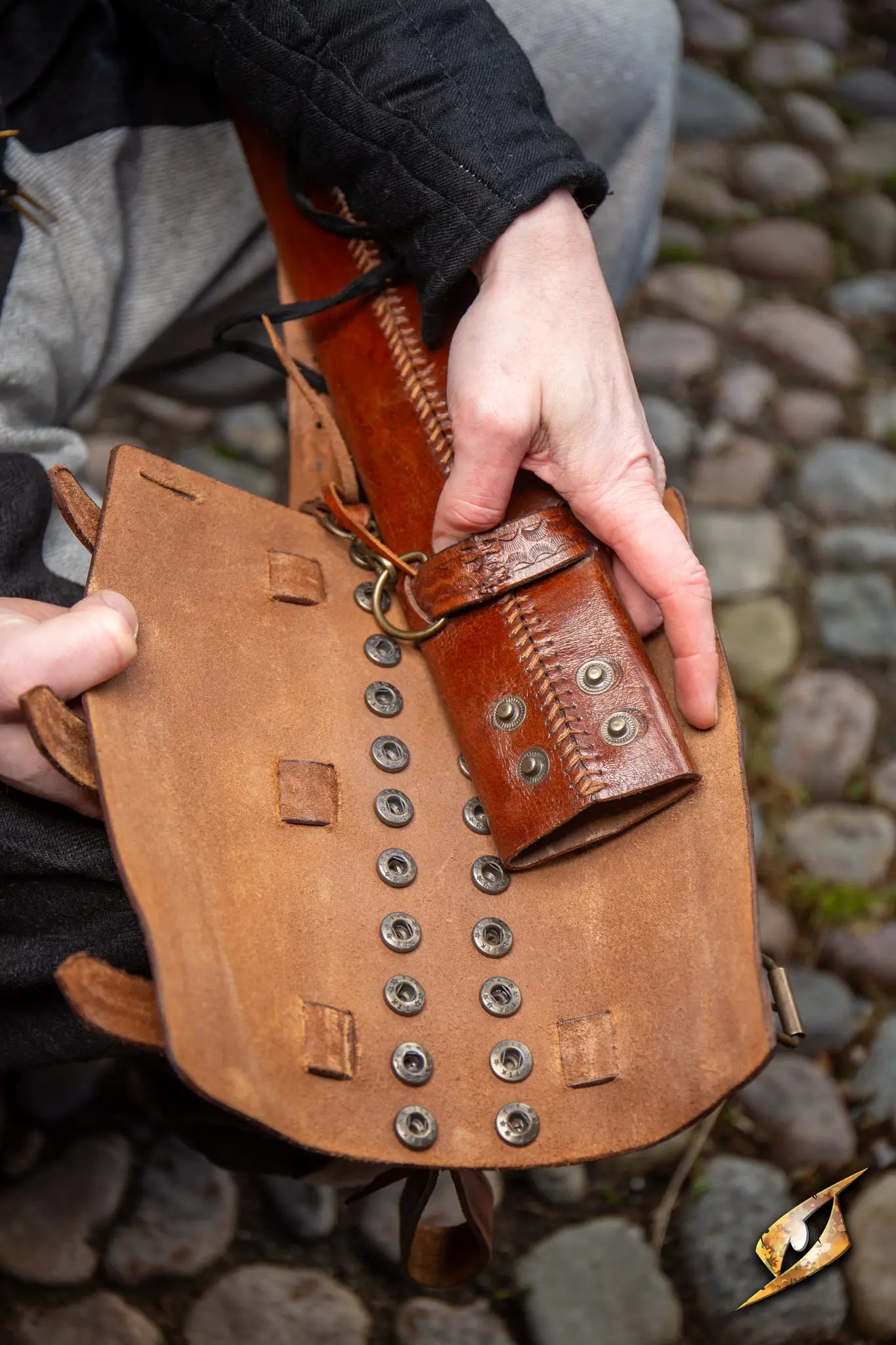 Detailed view of an Adjustable Scabbard showcasing its craftsmanship and unique fastening mechanism.