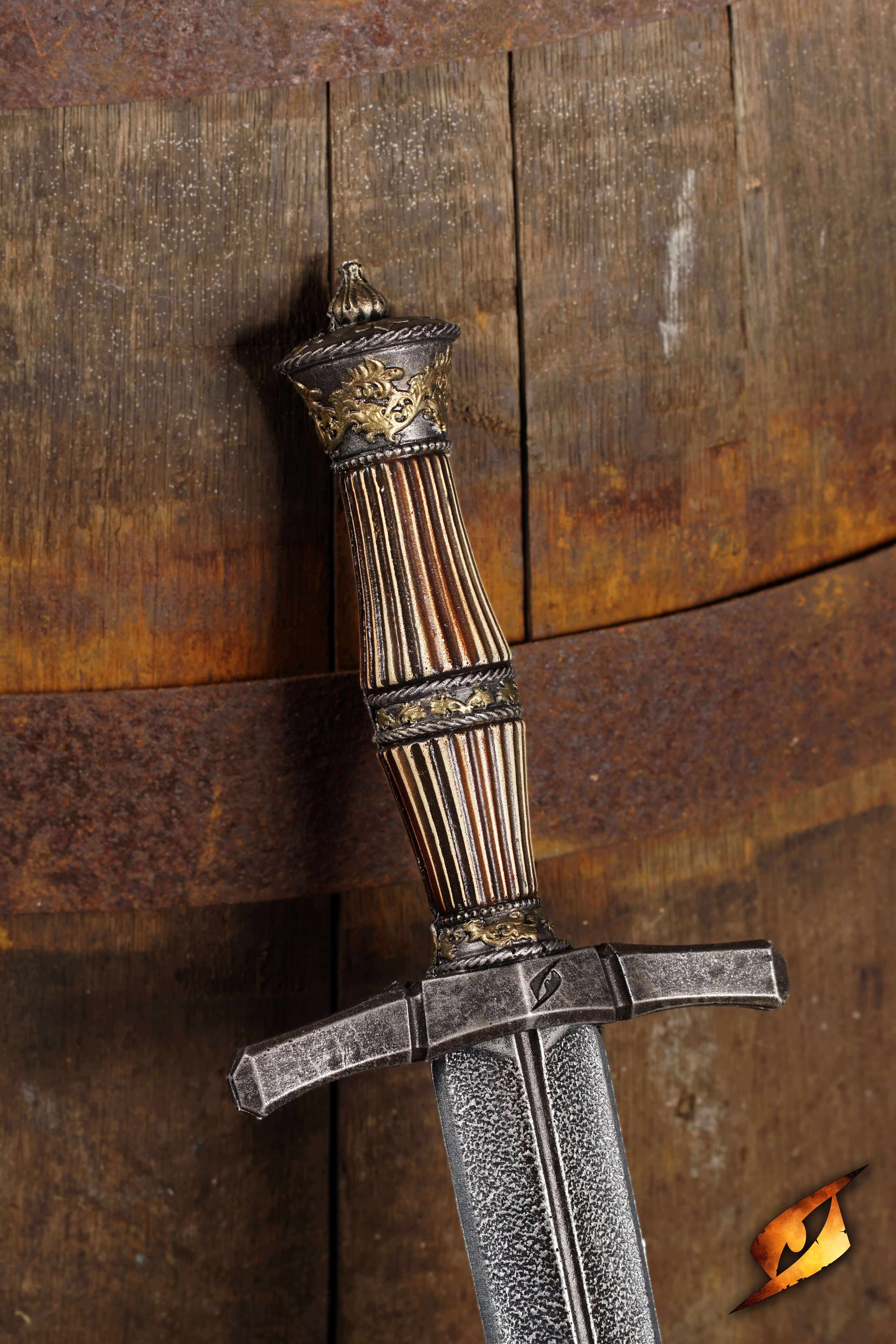 Blocking Dagger with ornate handle design, resting against a rustic wooden barrel background.