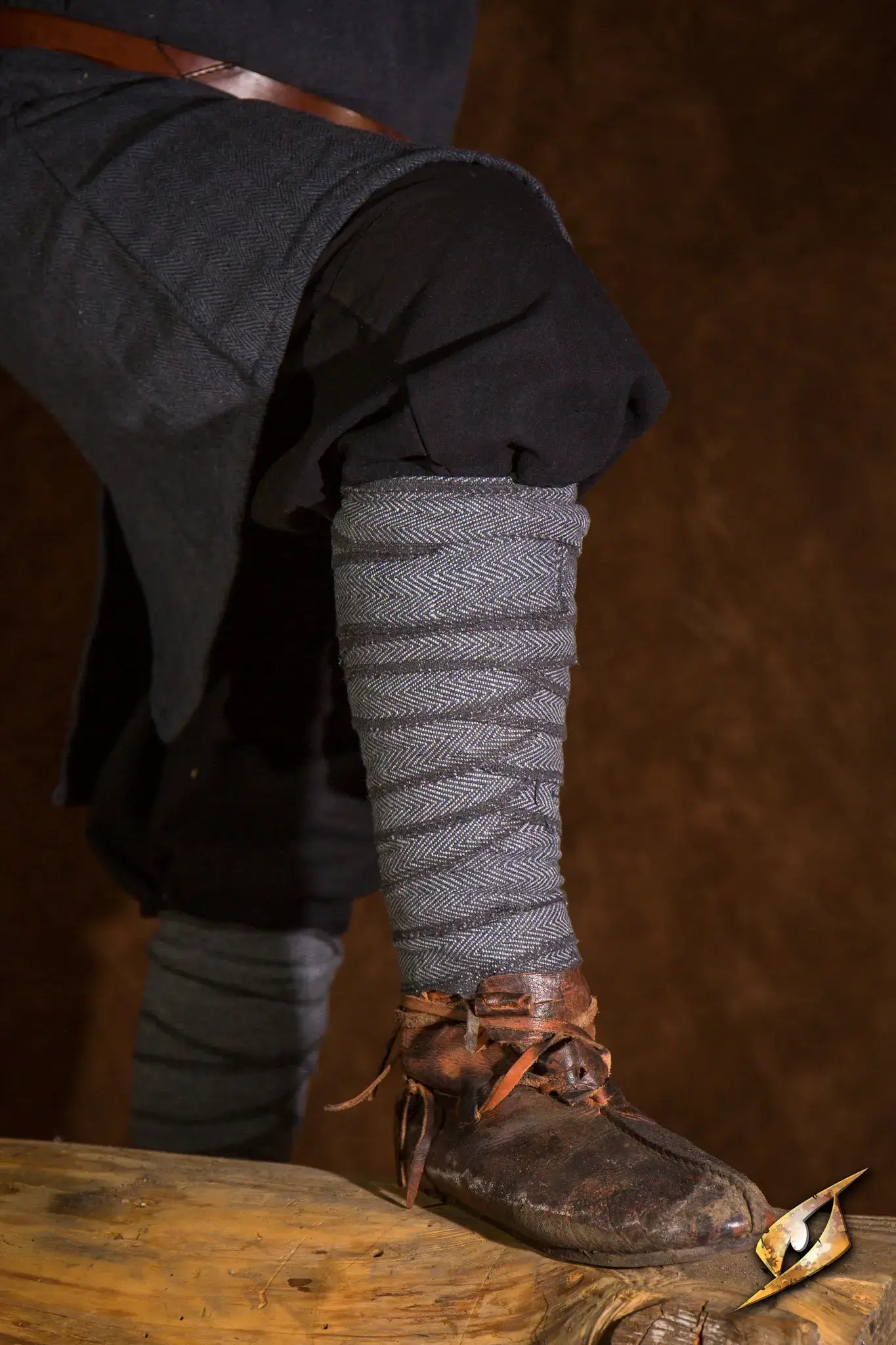 Woodland Leg Wraps worn by a character in a historical setting, featuring intricate wrapping design and rustic footwear.