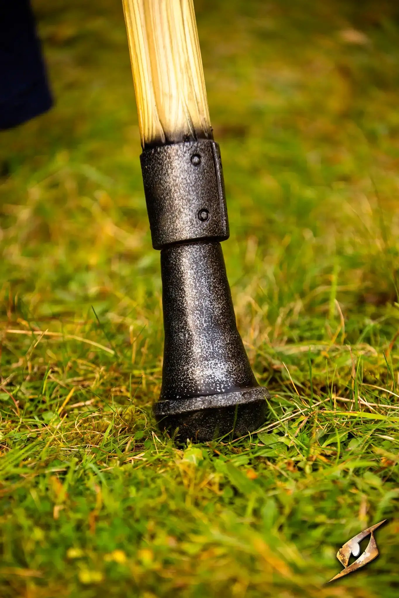 Battle Standard - Butt Cap Male attached to a pole on grass, providing stability for battle standard setup.