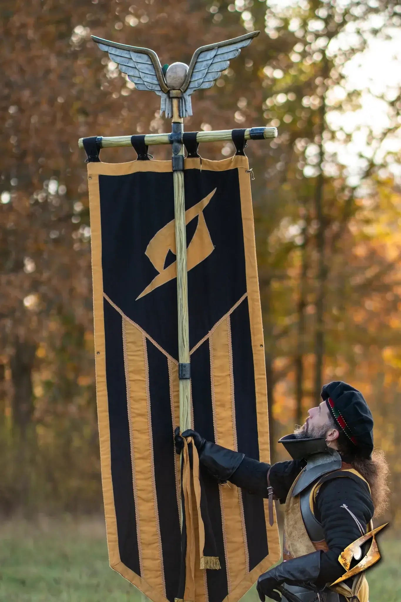 Battle Standard - Short Pole displayed by a warrior holding a banner in an autumn setting.