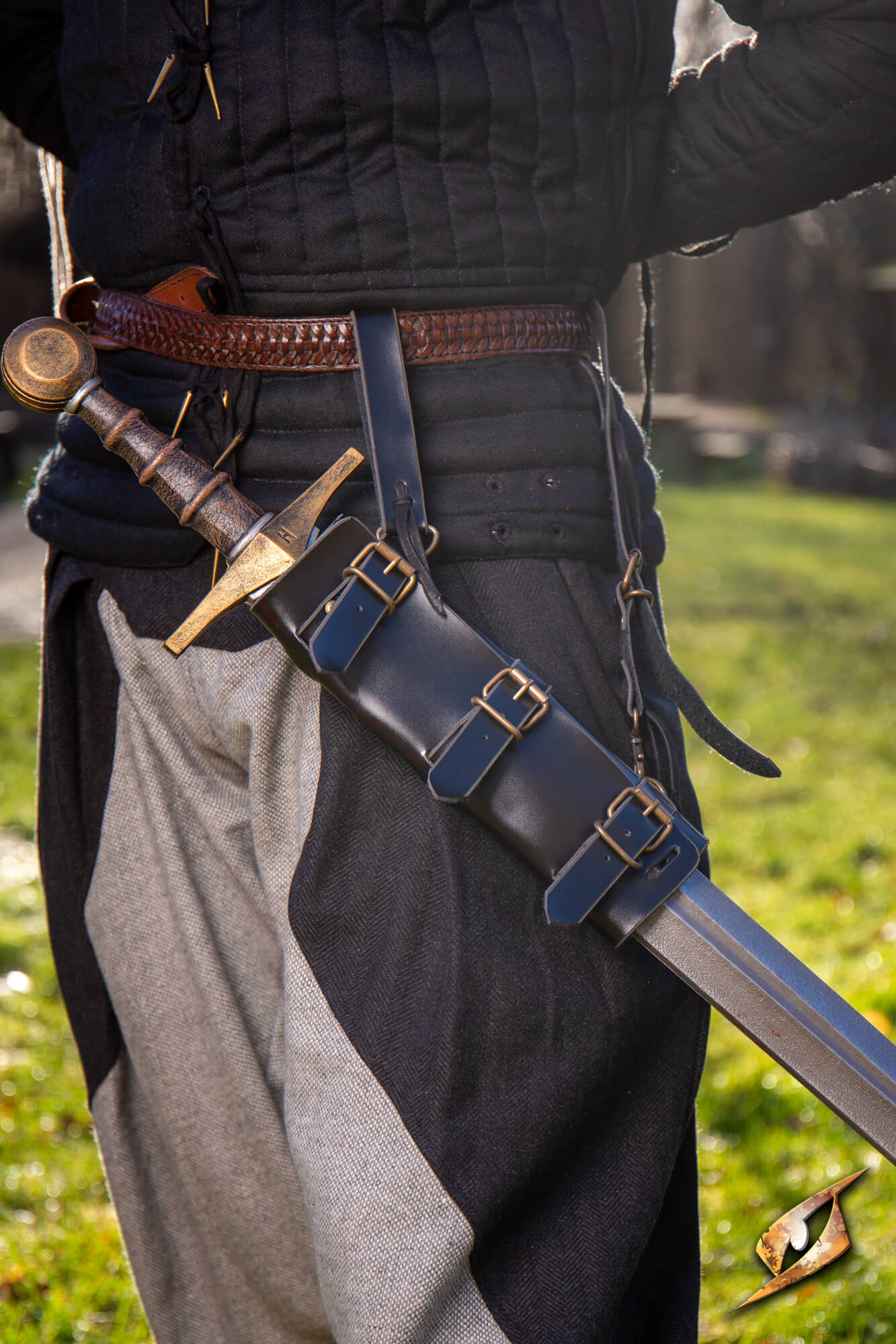 Adjustable Scabbard - Faux Leather shown with sword in a stylish medieval outfit.