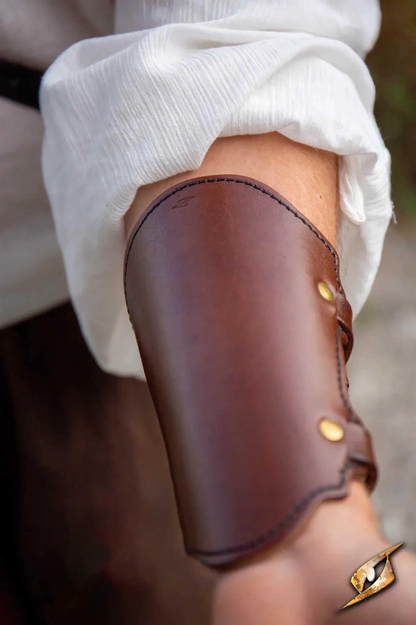 Close-up of a leather Archery Bracer on a forearm, emphasizing craftsmanship and durability for archery enthusiasts.
