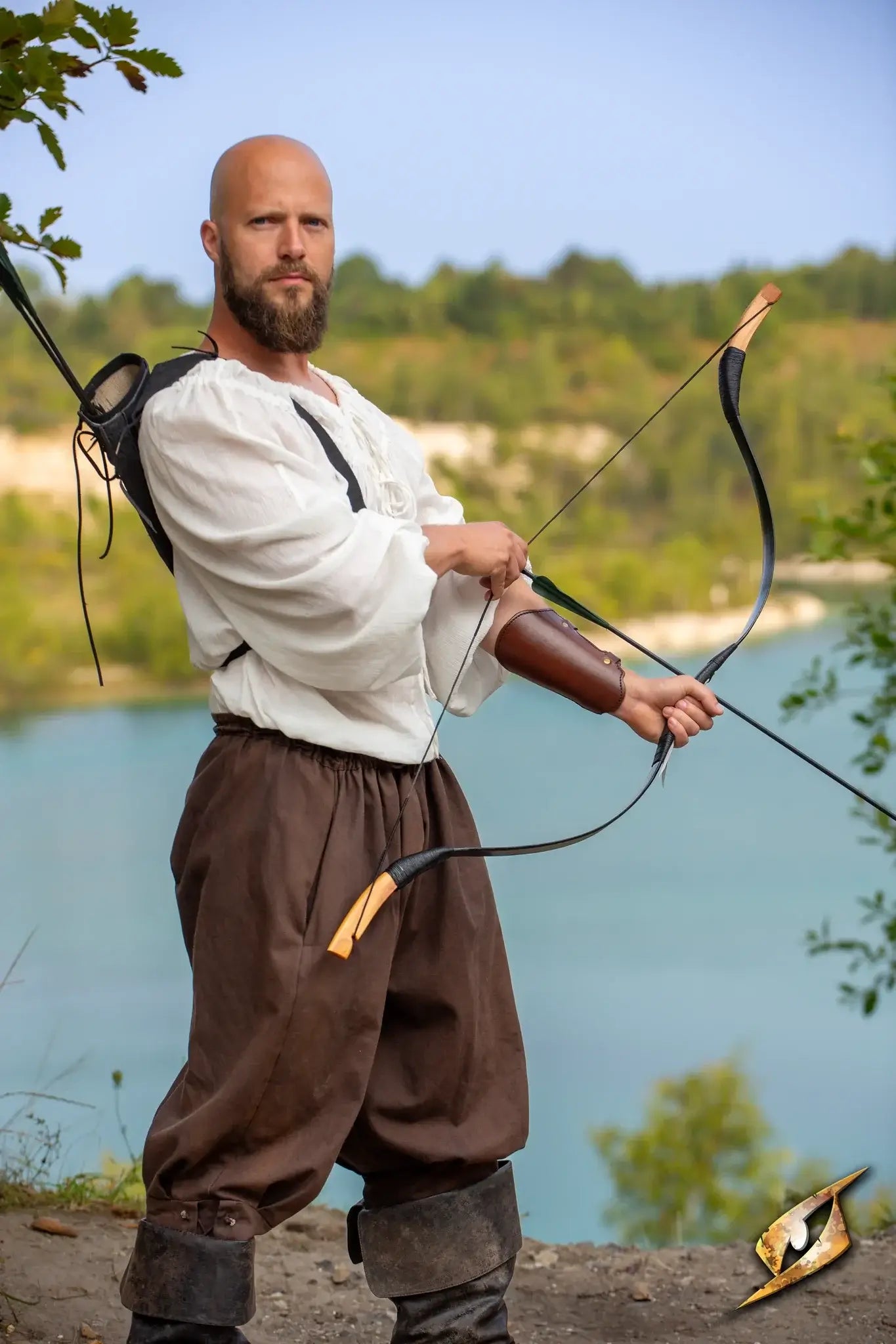 A skilled archer wearing an Archery Bracer, preparing to shoot an arrow by a serene lake.