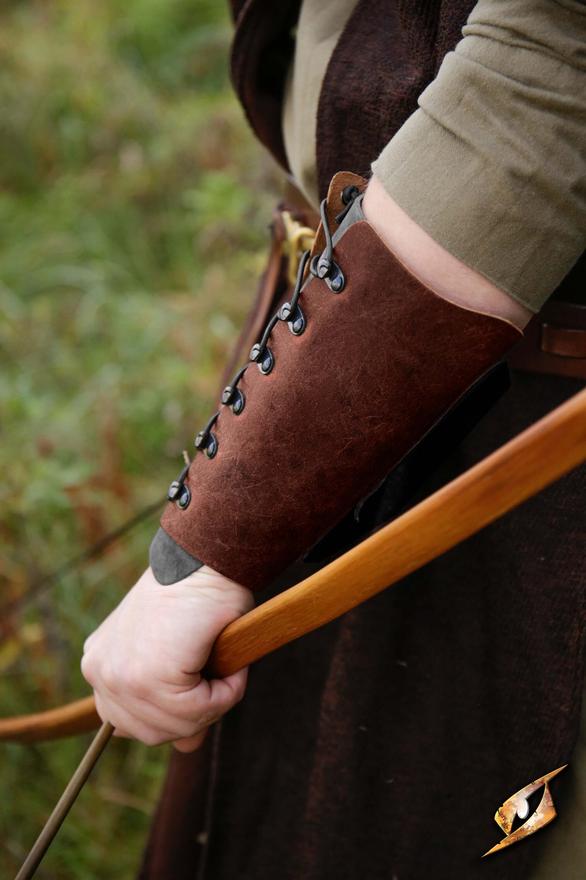 Glade Warden Bracer in brown leather showcased on arm with bow, combining comfort and precision for archery.