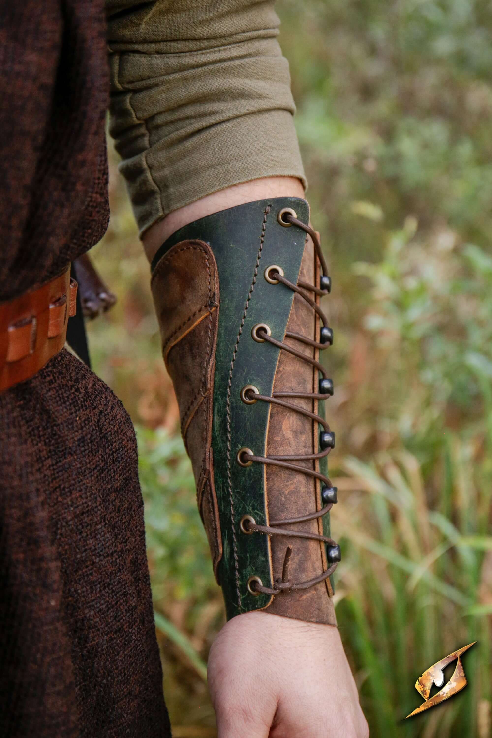 Glade Warden Bracer showcased on a forearm in a natural setting, combining style and protection for archers.