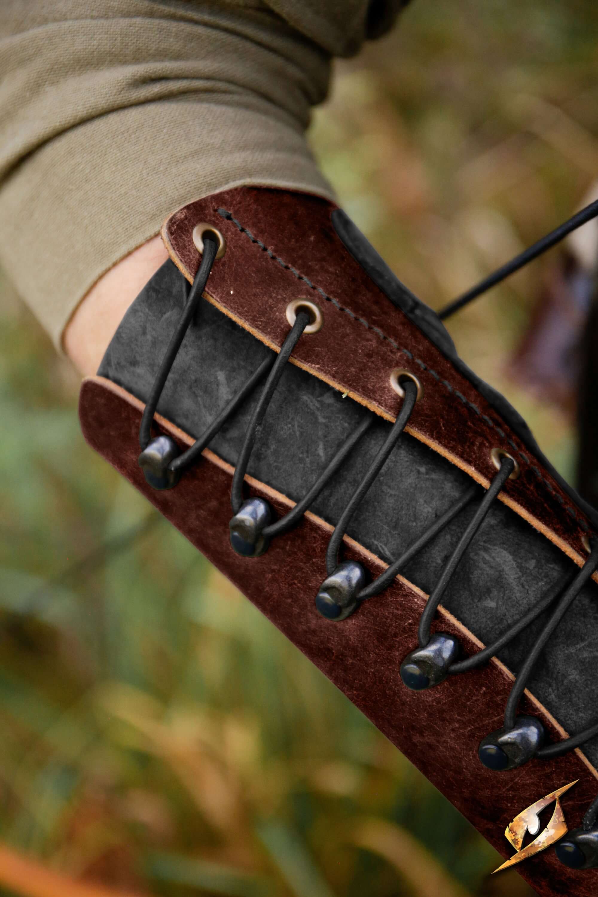 Glade Warden Bracer shown on forearm, showcasing its leather design and lacing for archery enthusiasts.