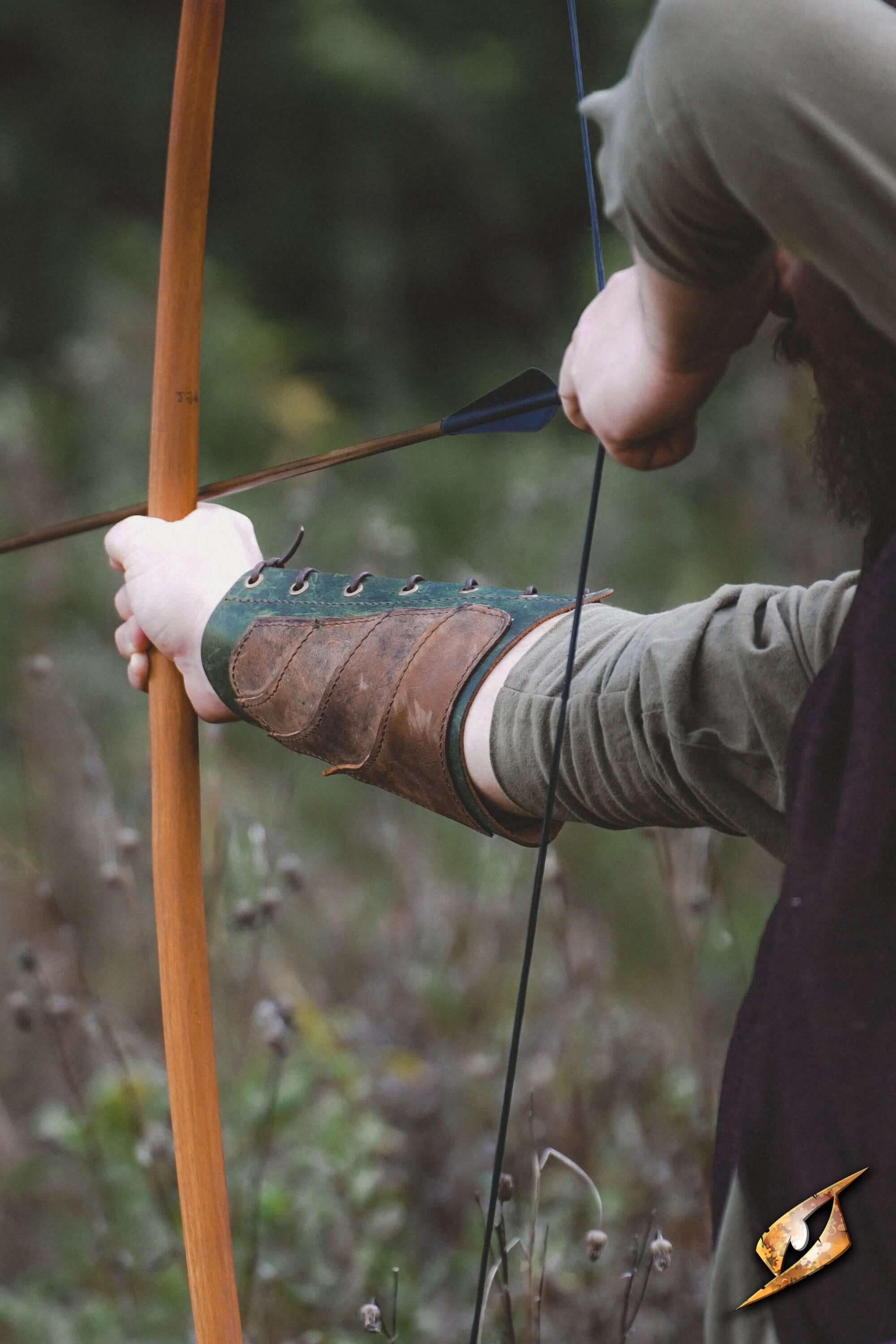 Person wearing a Glade Warden Bracer while drawing a bow for archery in a forest setting.