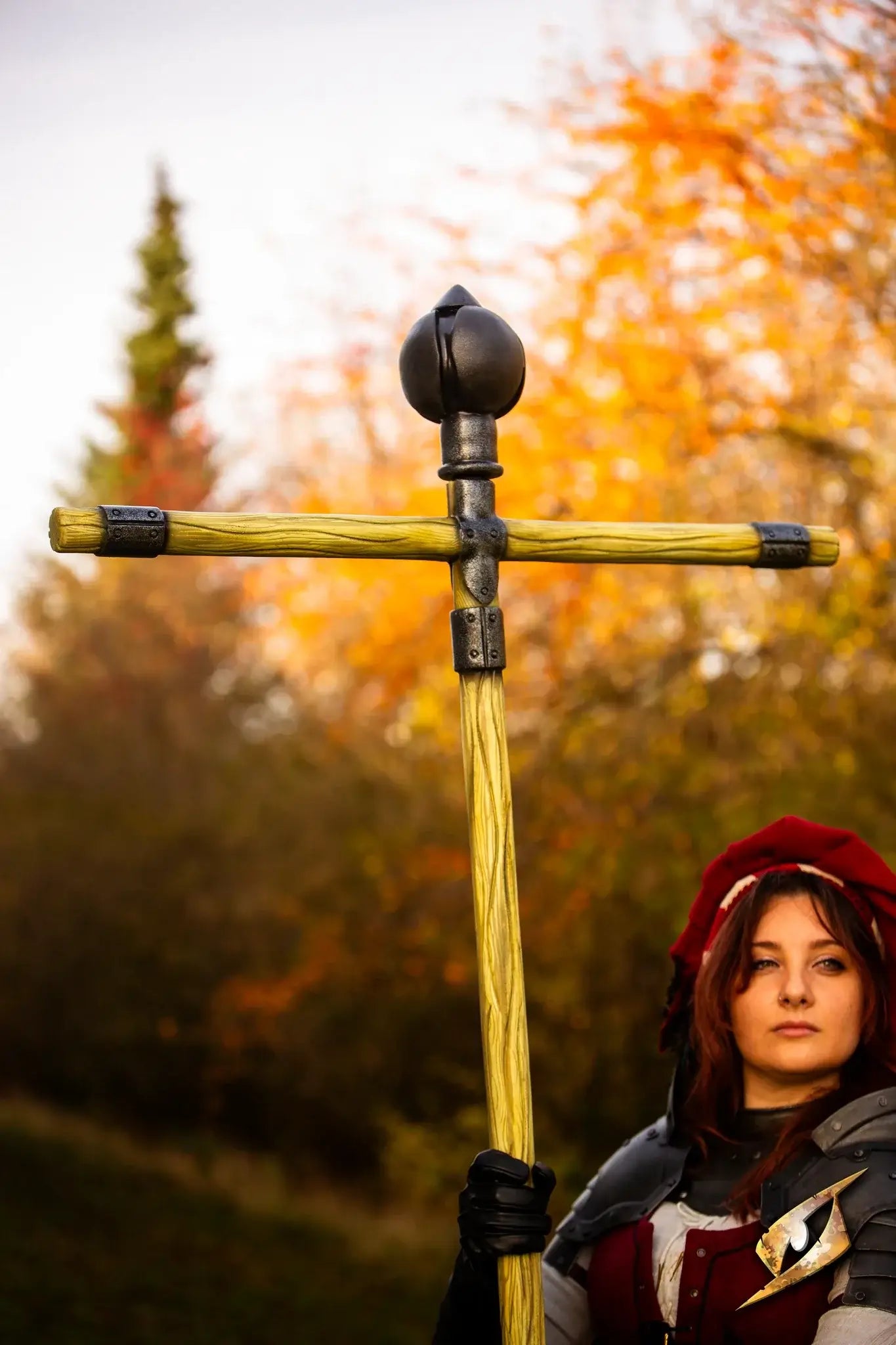 Battle Standard - Cross Top held by a cosplayer in a colorful autumn setting.