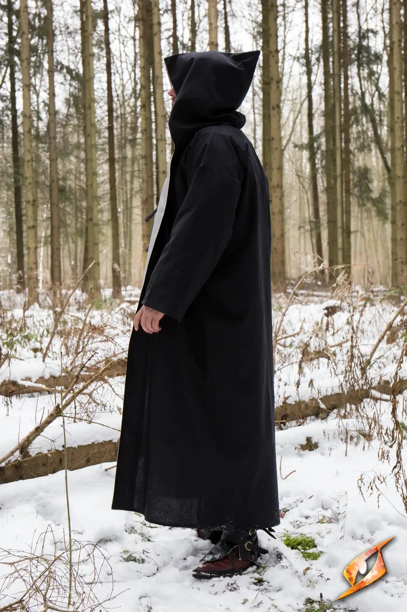 Magician Robe worn by a figure in a snowy forest, showcasing mystical style and silhouette.