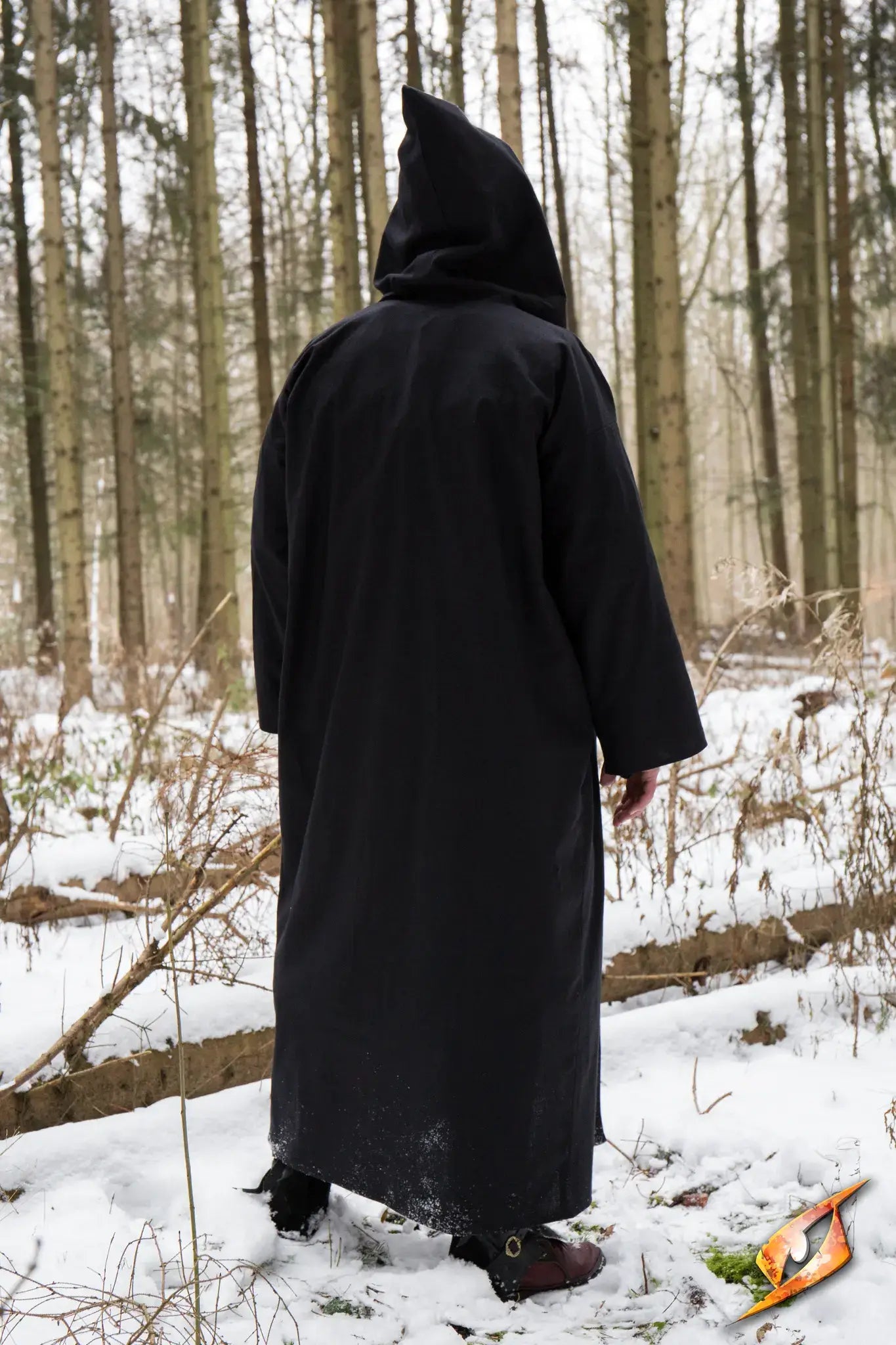 Person wearing a Magician Robe in a snowy forest, perfect for casting powerful spells.