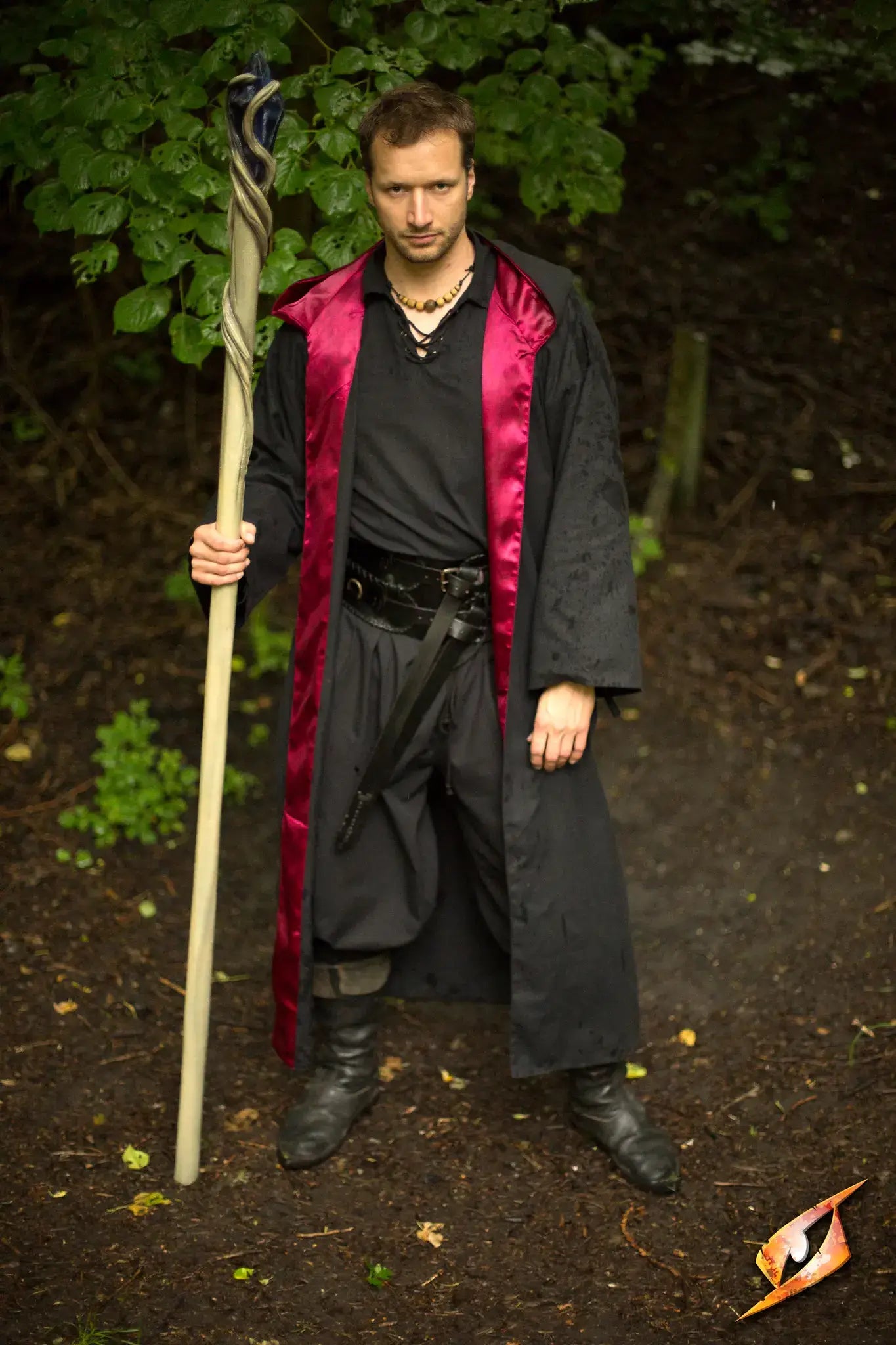 Magician Robe worn by a male mage holding a staff in a forest setting, showcasing the powerful allure of magic.