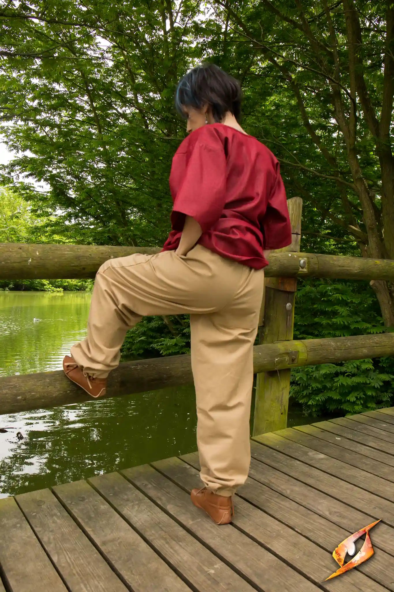 Person wearing Basic Pants standing by a pond, showcasing style and comfort in a natural setting.