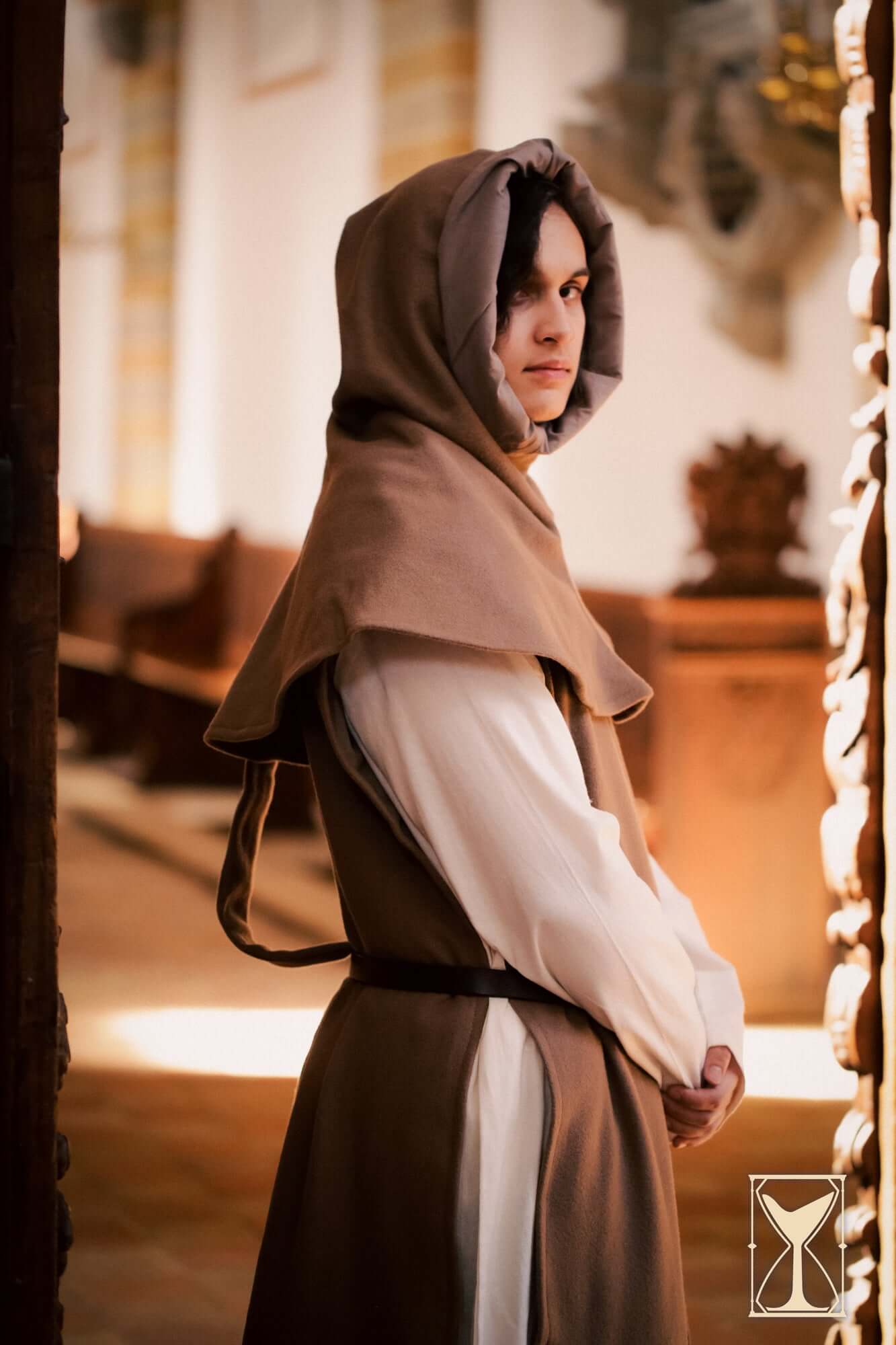 Simple Liripipe Hood - Brushed Wool showcased on a model in a medieval setting, highlighting its style and practicality.