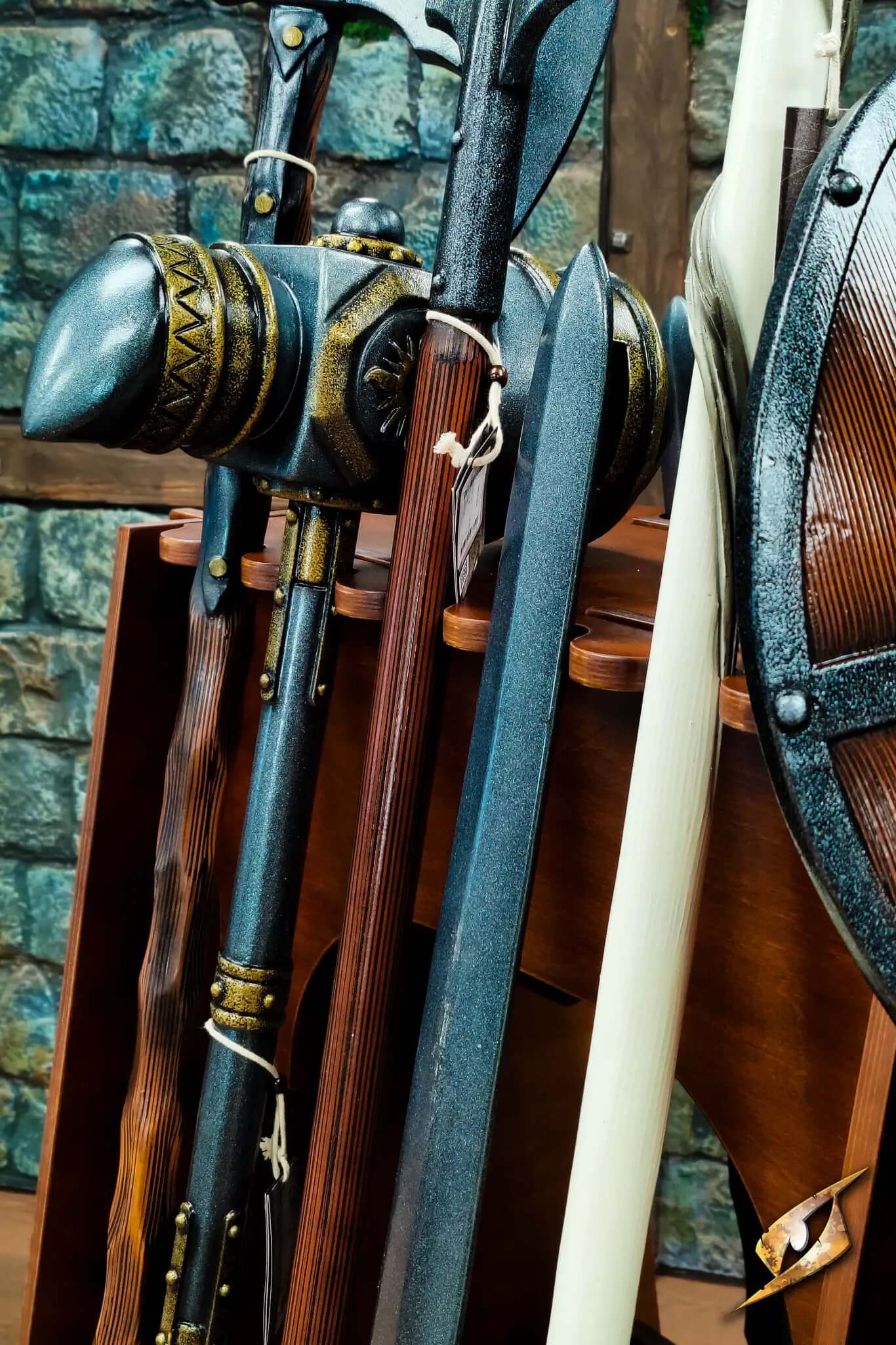 Polearms Rack displaying various two-handed weapons including spears and staffs against a wooden background.
