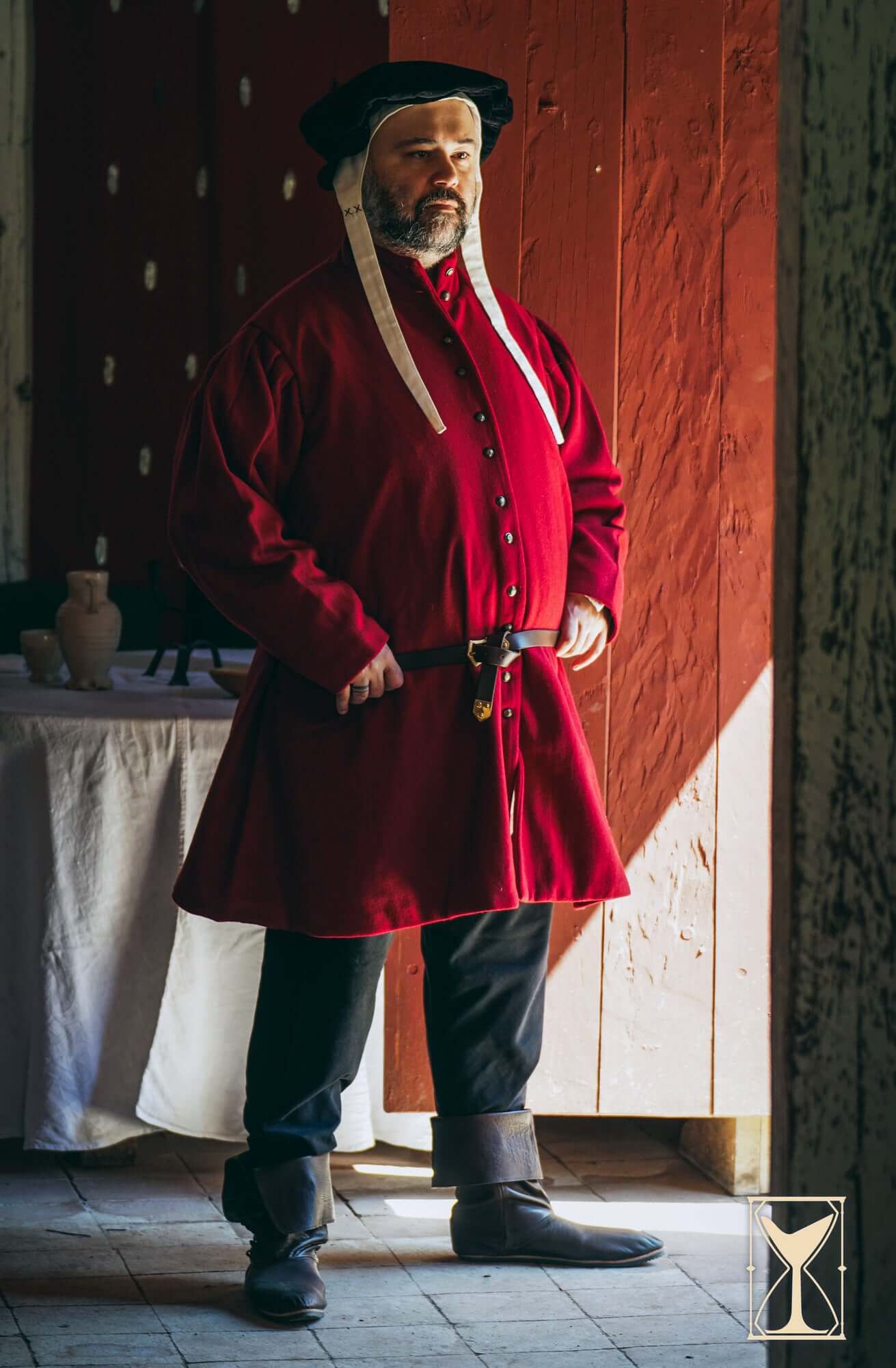Man wearing a red Surcoat Lorenzo, showcasing a 14th century noble style with multiple rows of buttons.