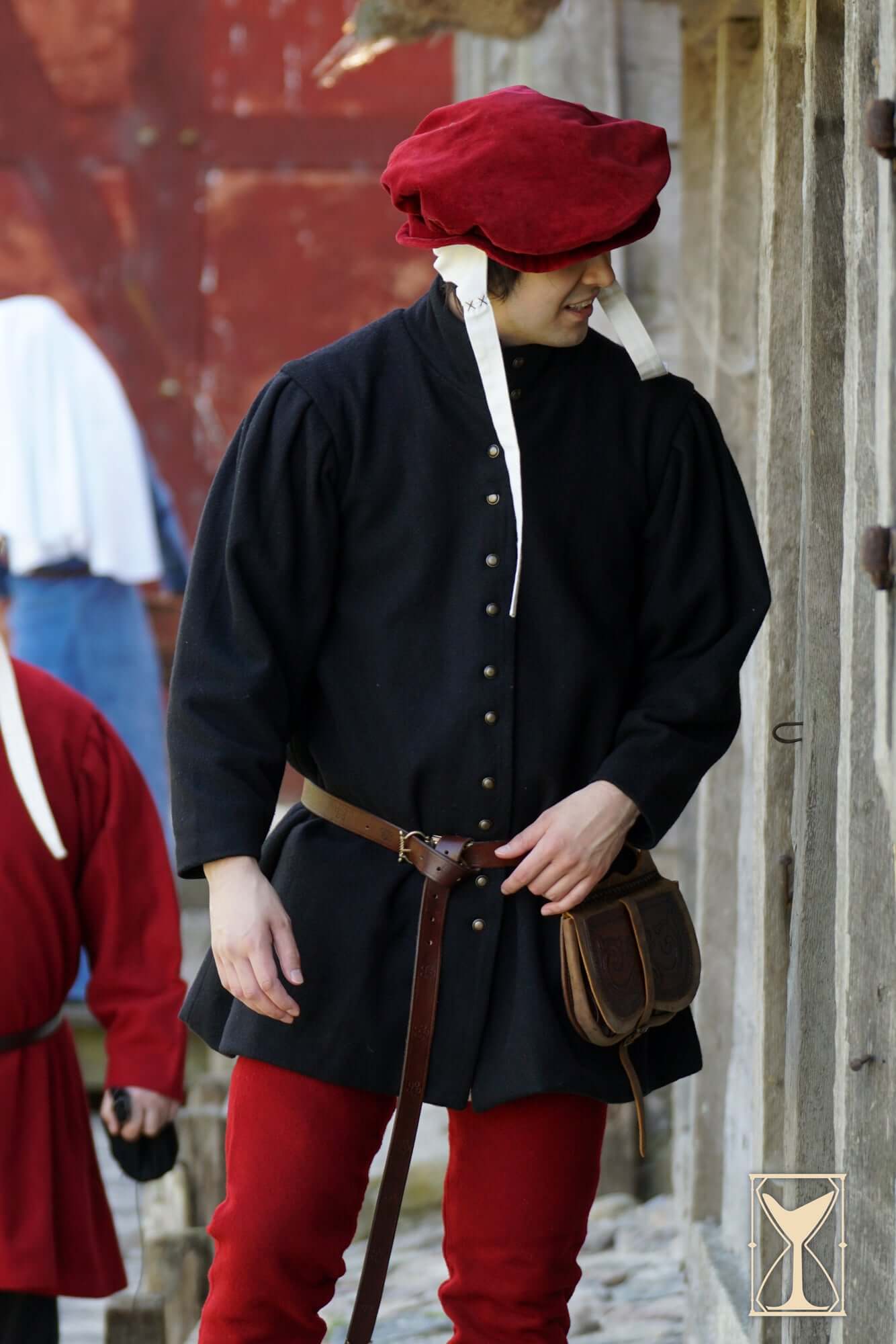 Surcoat Lorenzo worn by a man in historical attire with a red hat, showcasing 14th-century fashion.