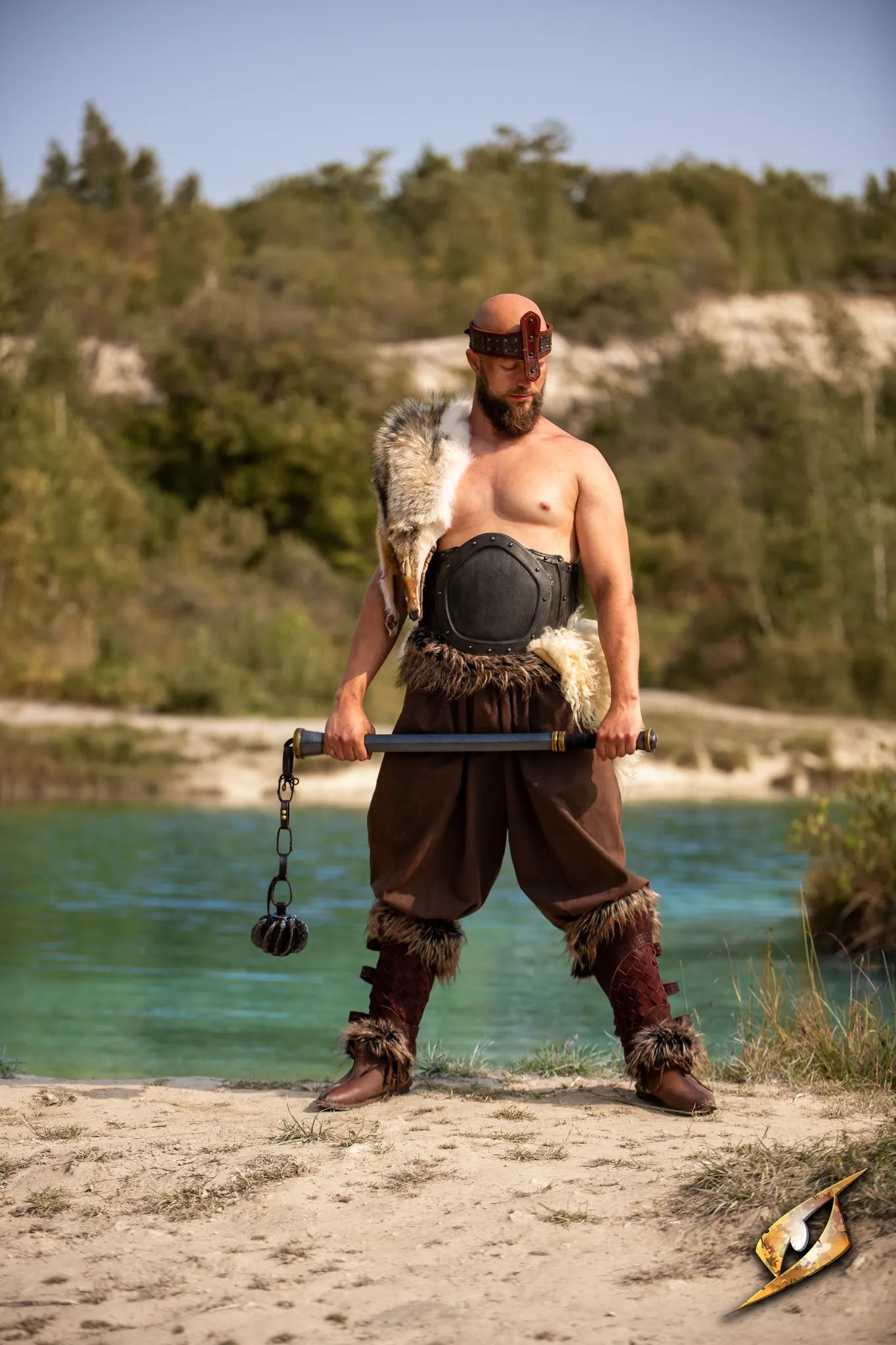 Steelstorm Flail Handle held by a warrior standing by a river with wilderness in the background.