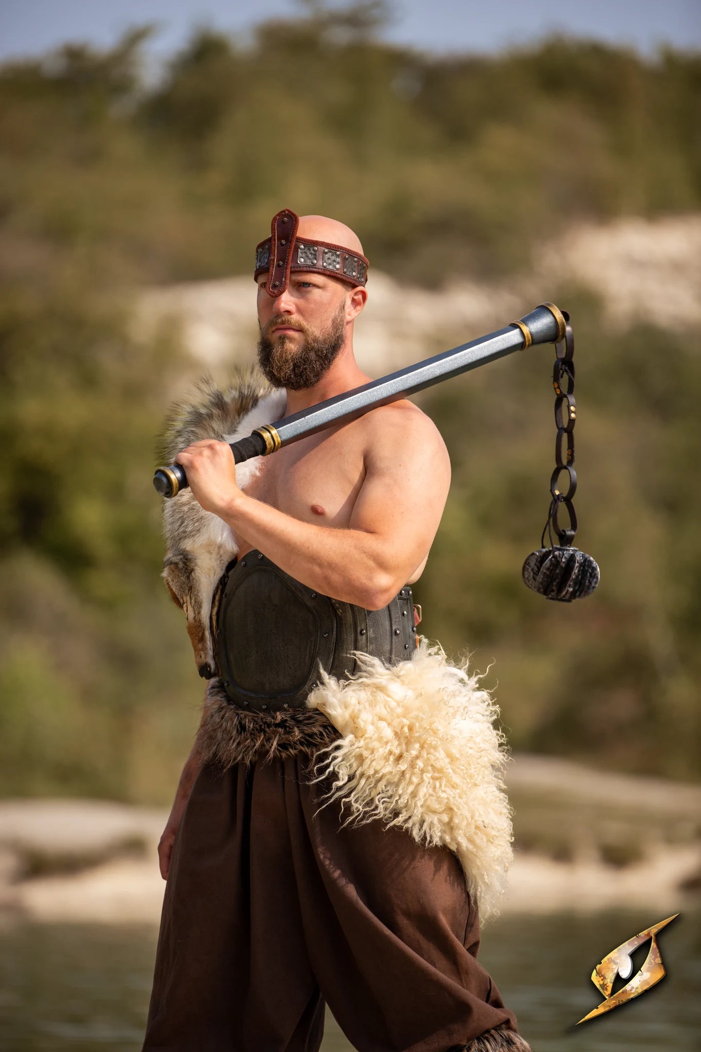 A warrior poses with a Steelstorm Flail Handle, showcasing strength and readiness for battle in an outdoor setting.