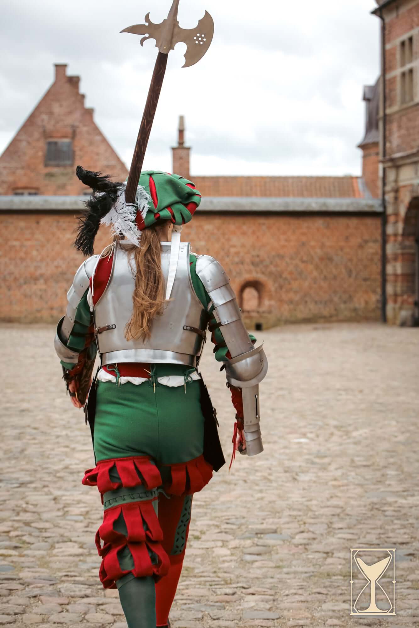 Landsknecht Cuirass - 1.6mm - Yoremade worn by a soldier with a weapon in a historic courtyard.