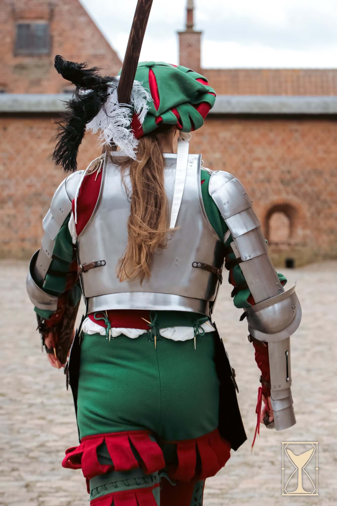 Landsknecht Spaulder - 1.6mm - Yoremade worn by a person in green and red costume, showcasing its distinct historical design.
