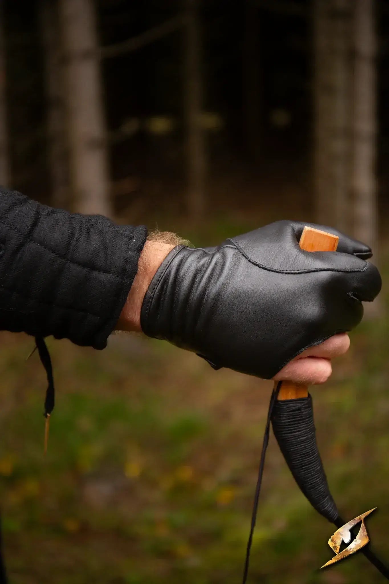 Archery Half-glove on a hand gripping an archery bow for precision and comfort in shooting.