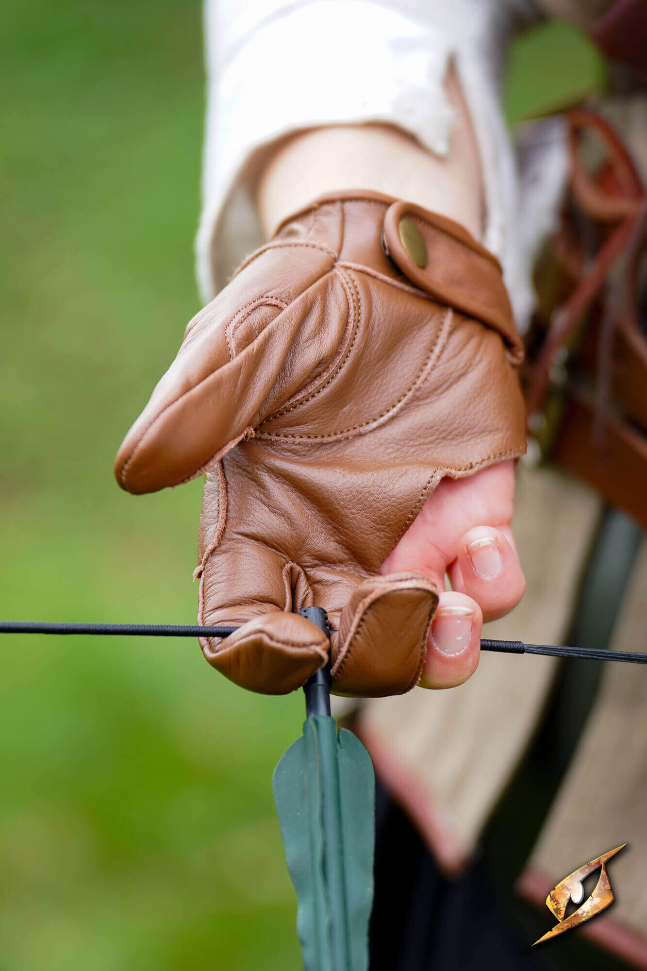 Archery Half-glove on hand gripping an arrow, showcasing comfort and dexterity for archers.