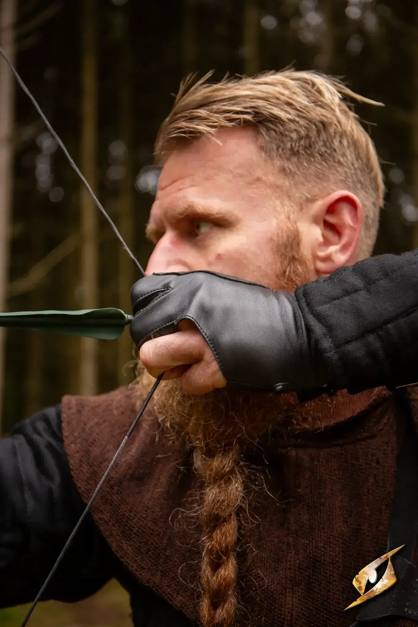 Archery Half-glove worn by an archer aiming an arrow in a forested area.