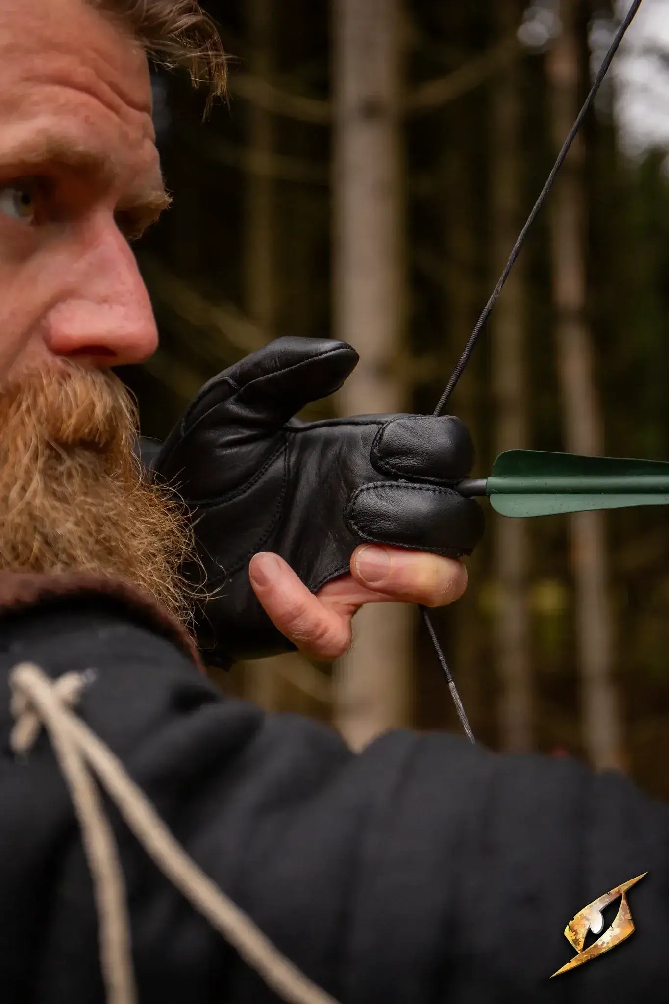Archer wearing an Archery Half-glove while drawing an arrow in a forest setting.