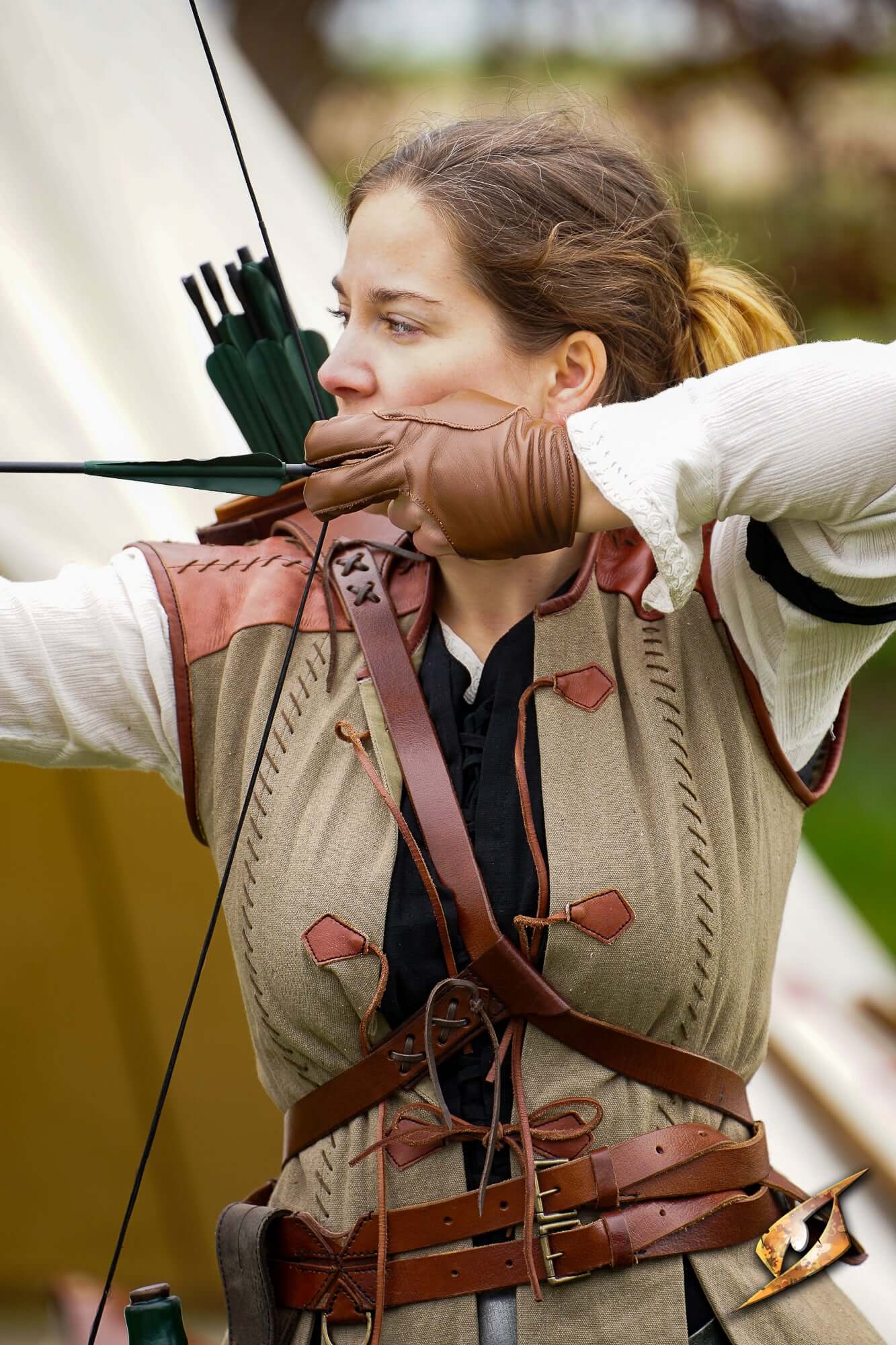 Archery Half-glove worn by an archer aiming a bow in a historical reenactment setting.