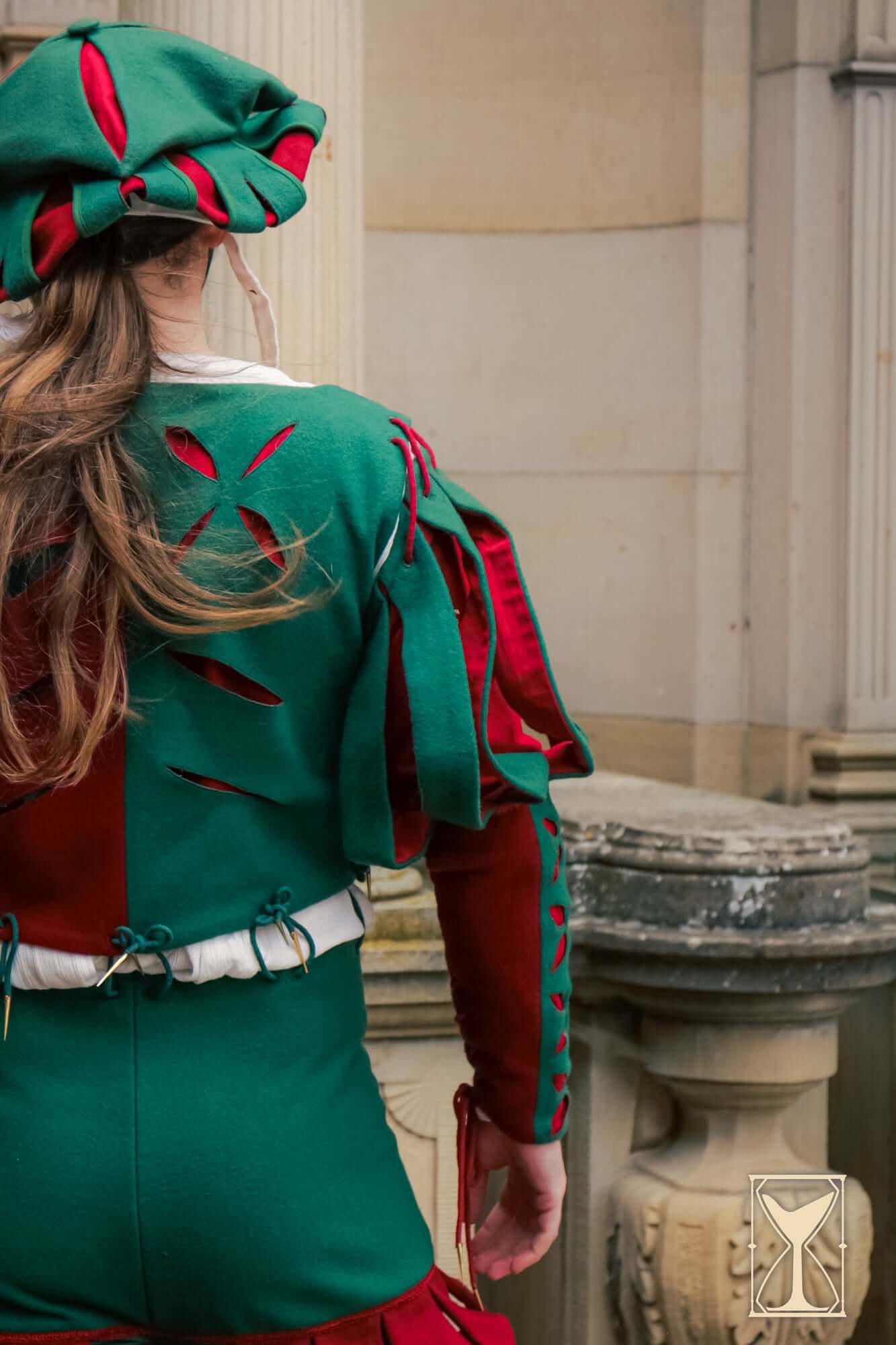 Landsknecht Bloom Sleeve showcasing elegant design and layered details in red and green fabric.