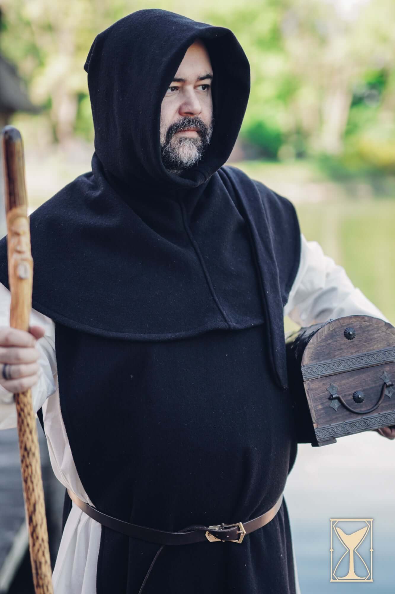 Cyclas Bernard worn by a man in a hooded tunic, embodying medieval style and history.