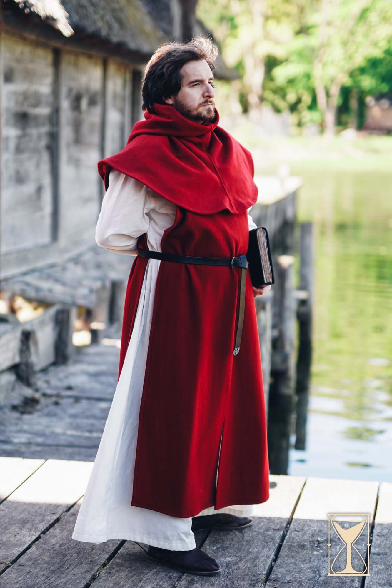 Cyclas Bernard sleeveless over-tunic worn by a man by the water, showcasing medieval attire.
