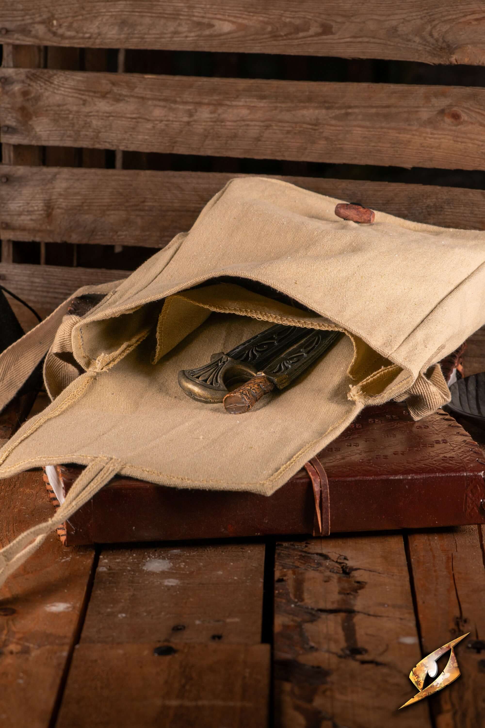 Traveler Satchel - Canvas open with tools inside on a wooden surface, ideal for everyday outdoor adventures.