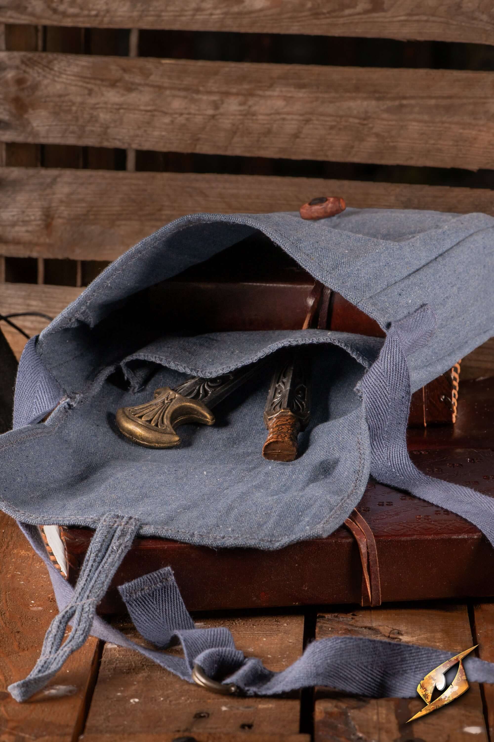 Interior view of Traveler Satchel - Canvas with decorative items, showcasing its rugged design and spaciousness.