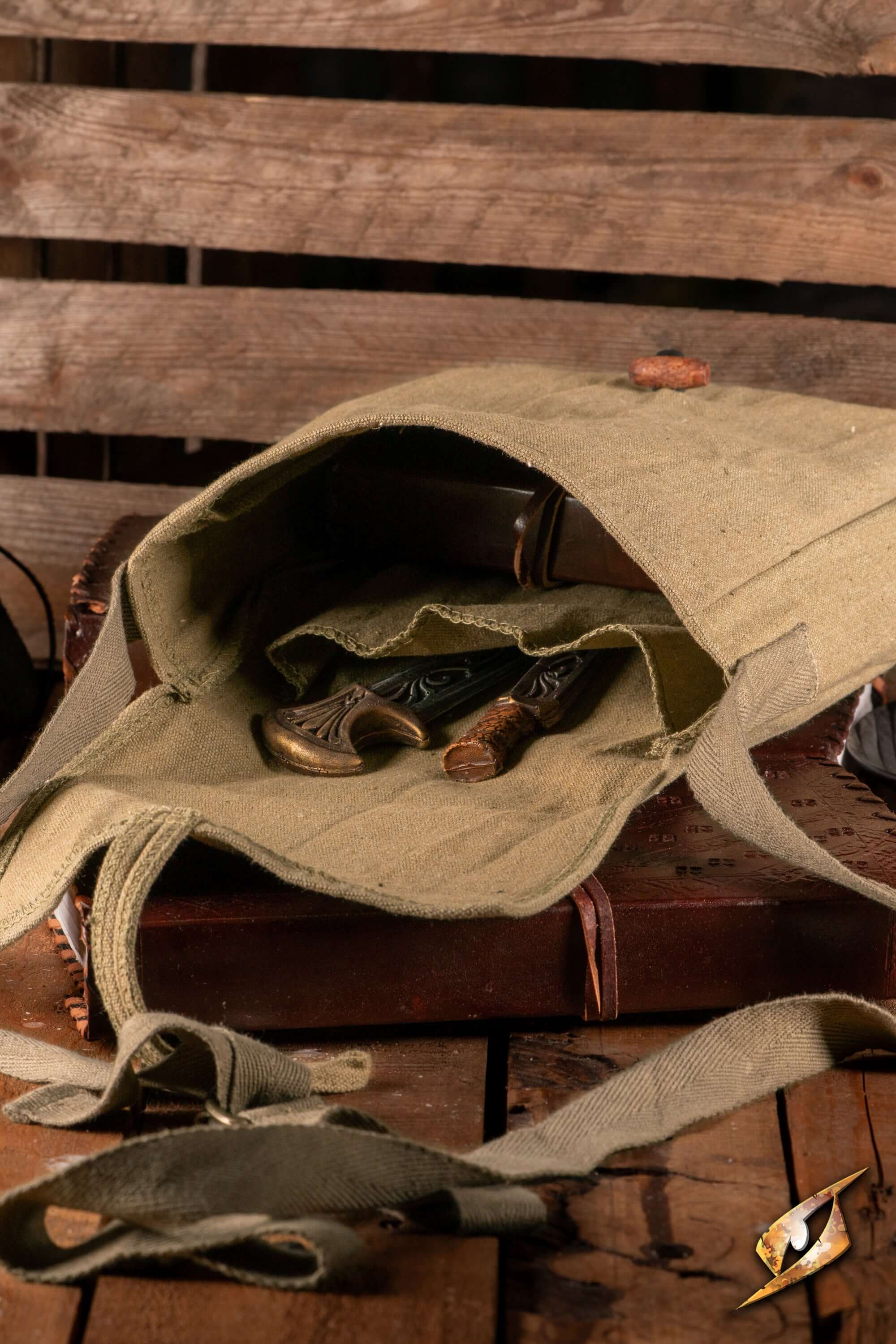 Traveler Satchel - Canvas open, showcasing interior with rustic items on wooden background.