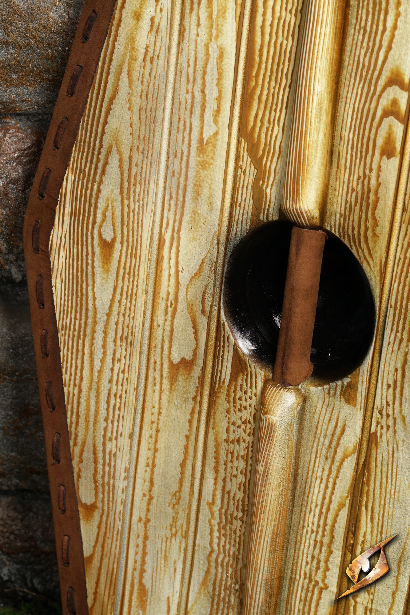 Close-up of a Germanic Shield's detailed wooden texture and leather edging, emphasizing its craftsmanship.