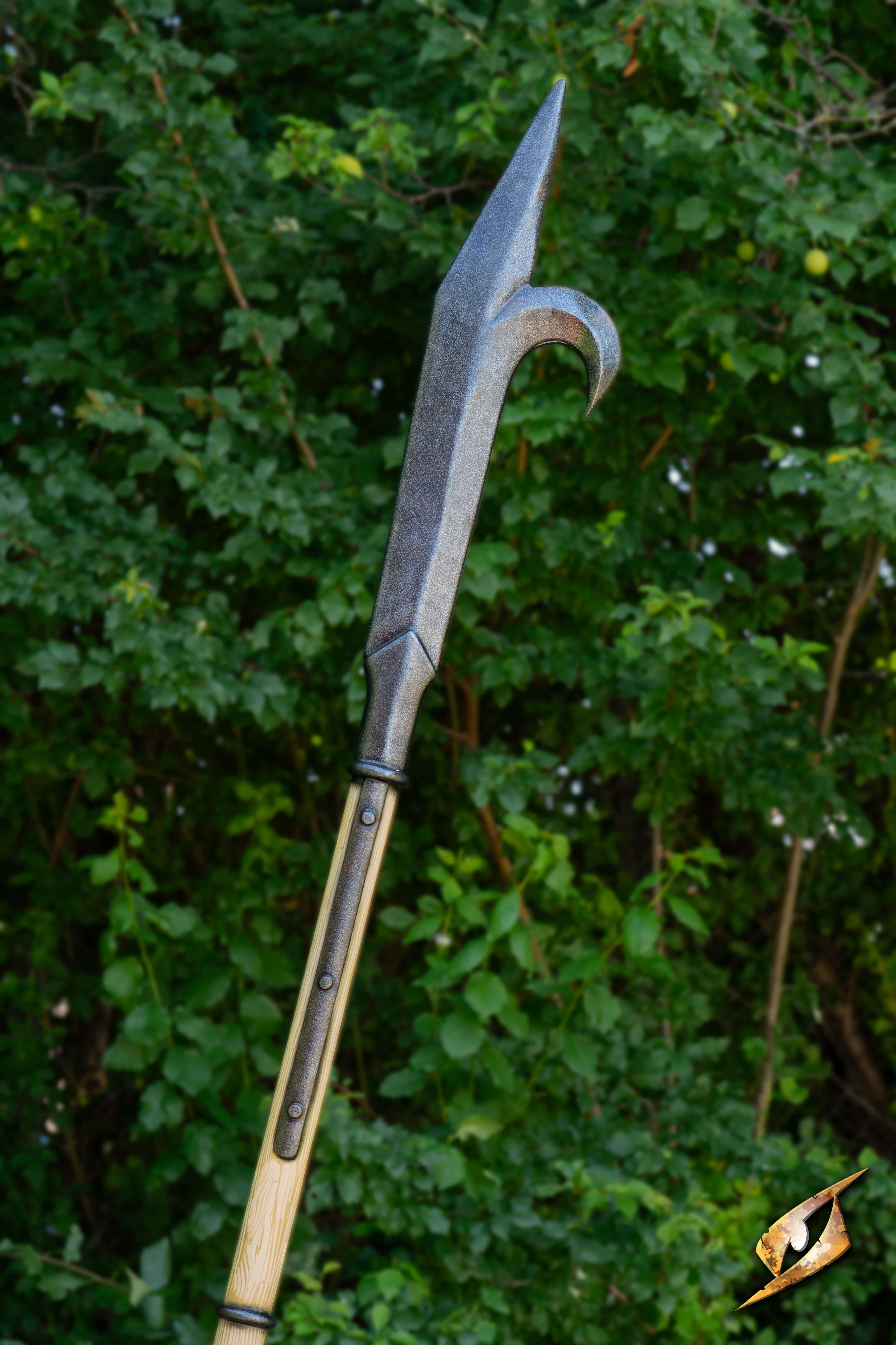 Bill Hook with a sharp spike and hook blade, showcased against a lush green background.
