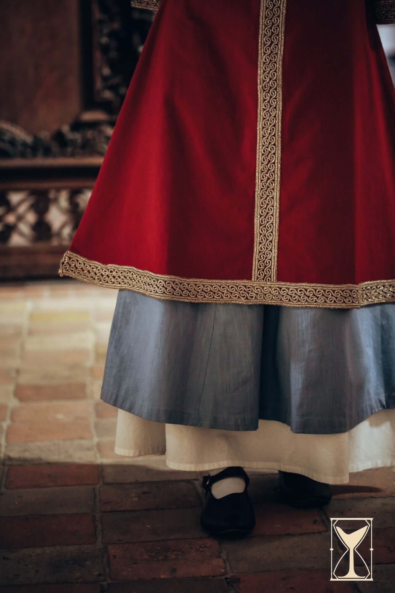 Overtunics Matilde with detailed woven trim and layered skirt in historical silhouette.