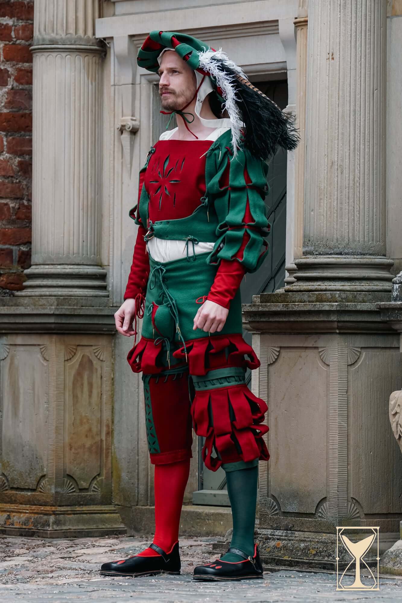 Landsknecht Doublet worn by a man in a striking green and red outfit, showcasing 16th-century historical fashion.