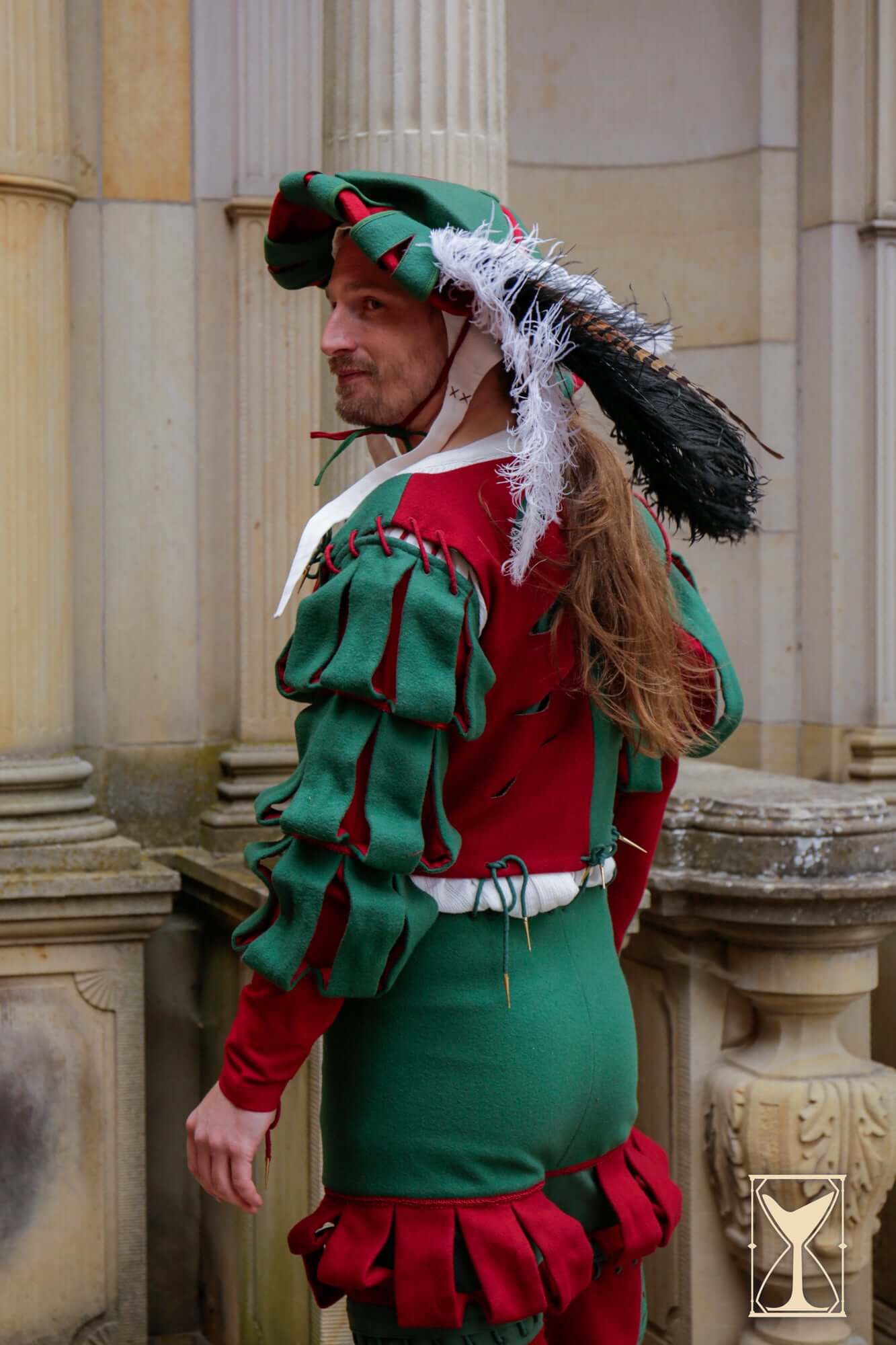 Man wearing a Landsknecht Doublet in historical costume with puffed sleeves and colorful design.