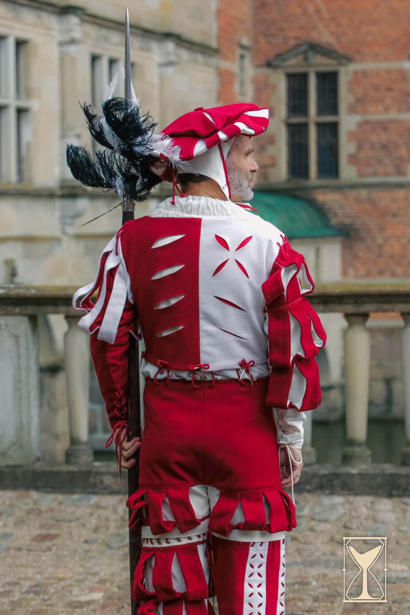 Landsknecht Doublet featuring bold red and white design with puff and slash details, capturing historical style.