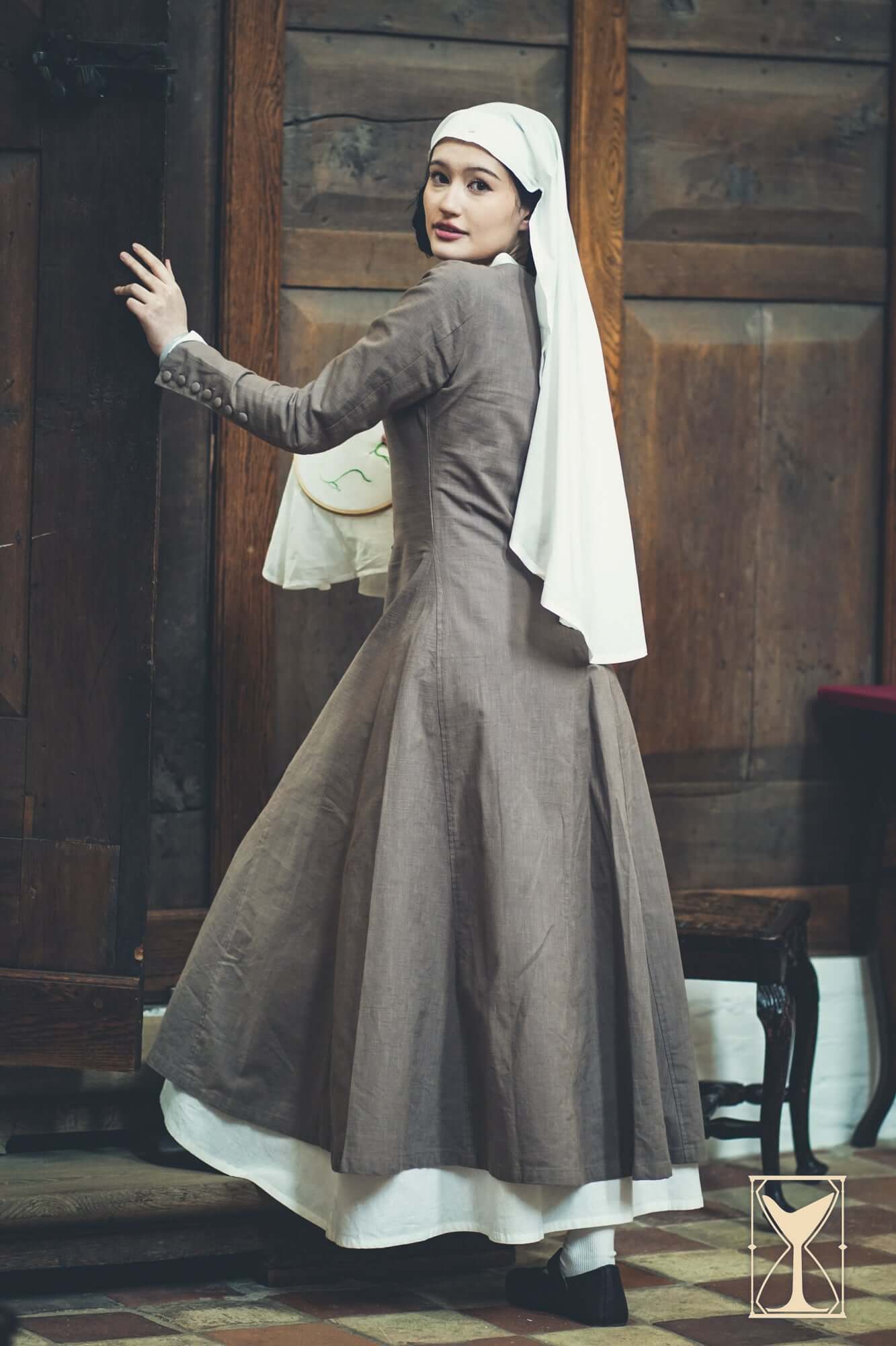Cotehardie Marian dress showcased on a model, featuring a central lacing system and tailored silhouette for historic authenticity.