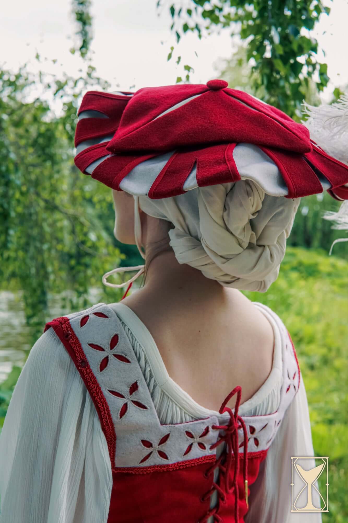 Woman wearing a Landsknecht Hat in red and white, styled for a historical costume, showcasing Renaissance fashion.