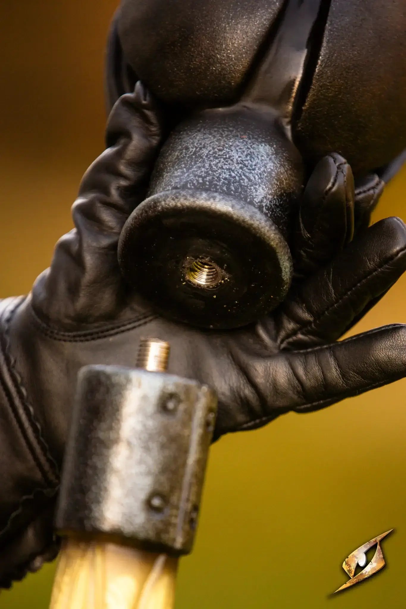 Close-up of Battle Standard - Lord's Orb Top held in a gloved hand, showcasing its regal design and craftsmanship.